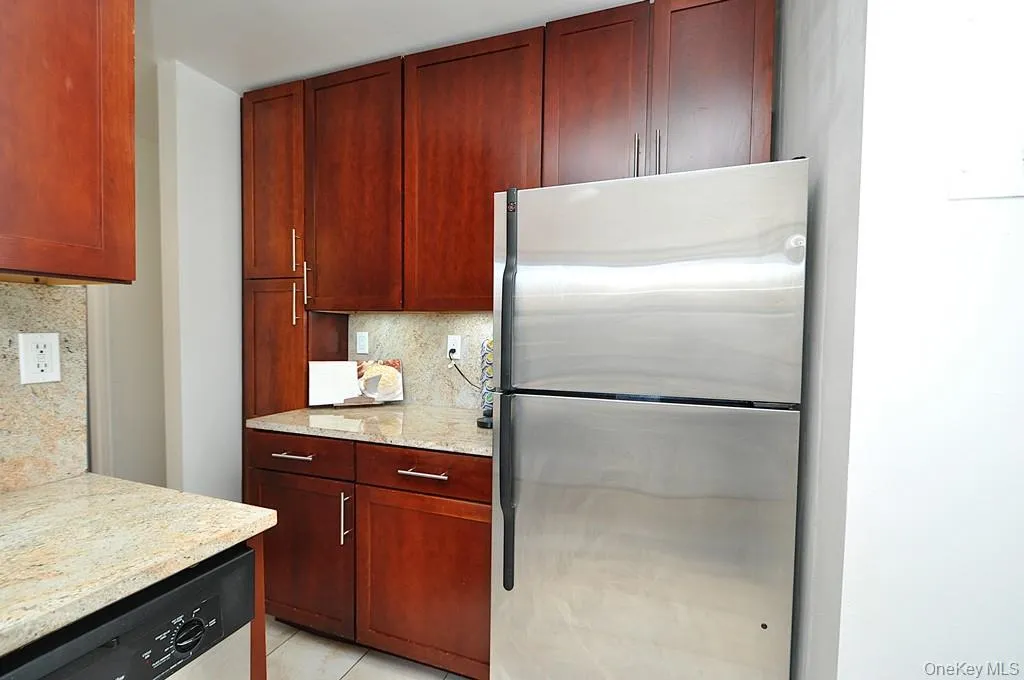 Renovated eat-in-Kitchen has Granite counters, 48" rosewood cabinets and Stainless Steel Appliances including a Dishwasher, microwave, range and refrigerator. Renovated eat-in-Kitchen has Granite counters, 48" rosewood cabinets and Stainless Steel Appliances including a Dishwasher, microwave, range and refrigerator.