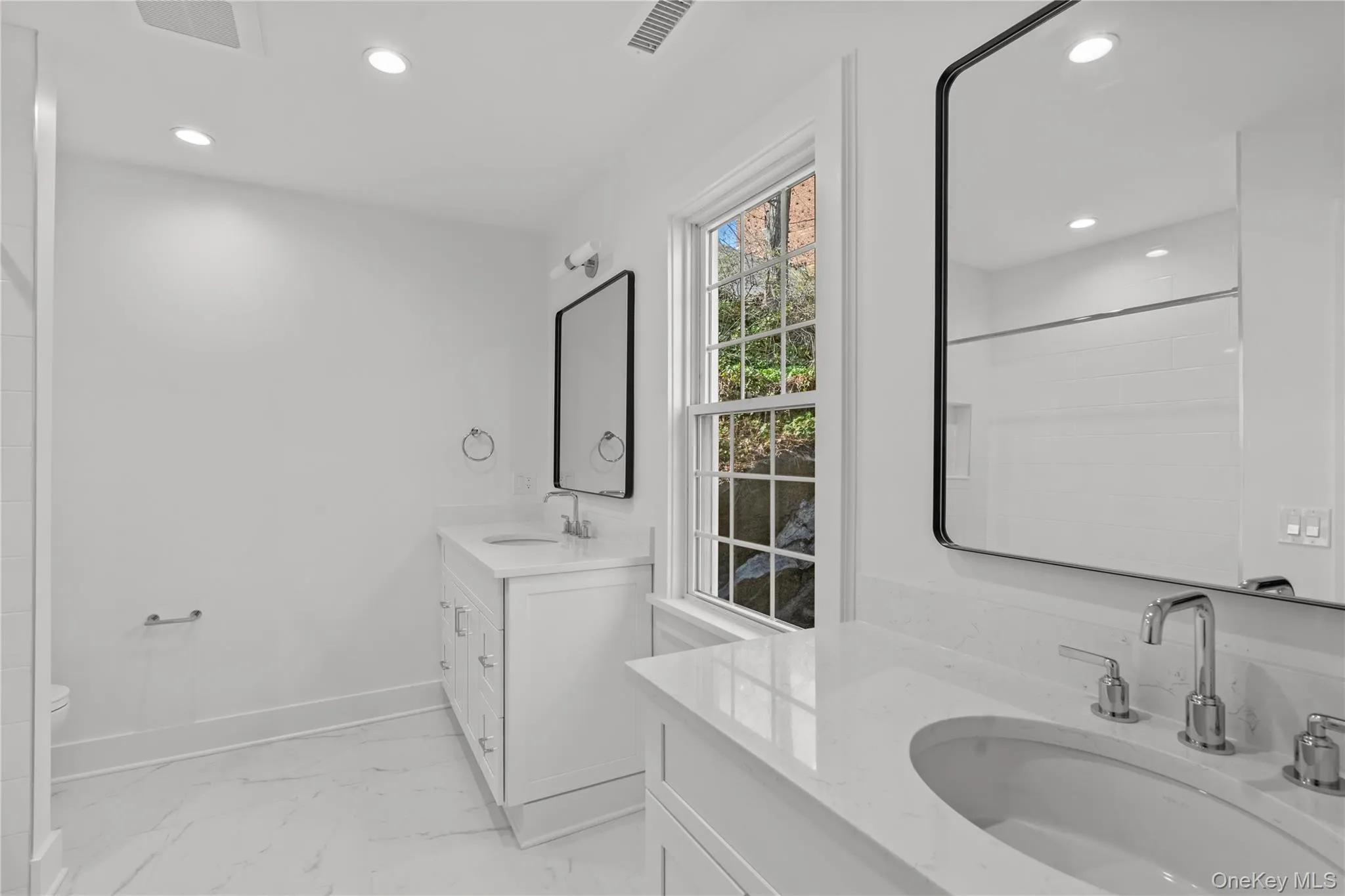 Second floor guest bathroom with matching vanities. Second floor guest bathroom with matching vanities.