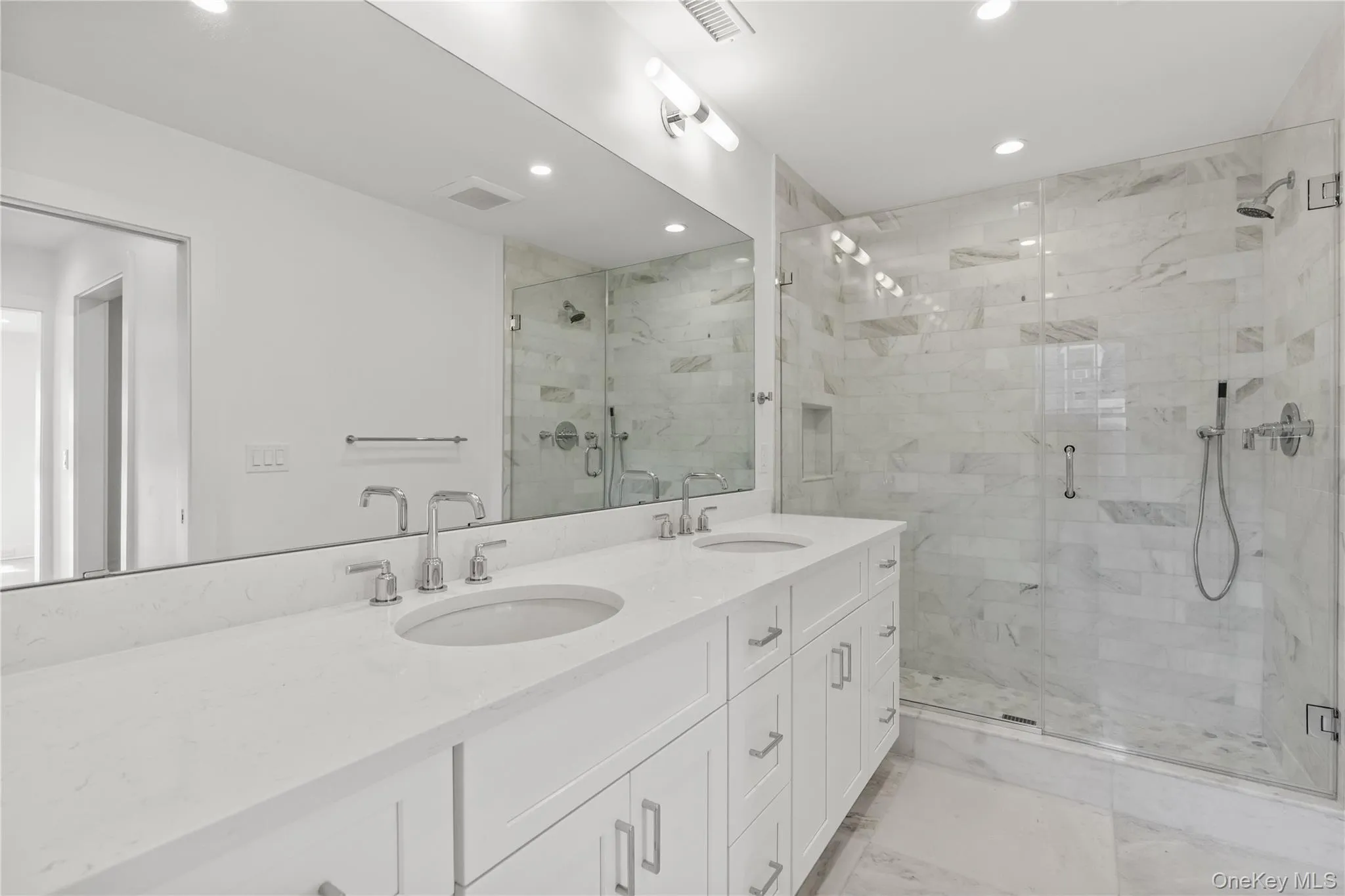 Full length double sink vanity and oversized stall shower. Full length double sink vanity and oversized stall shower.
