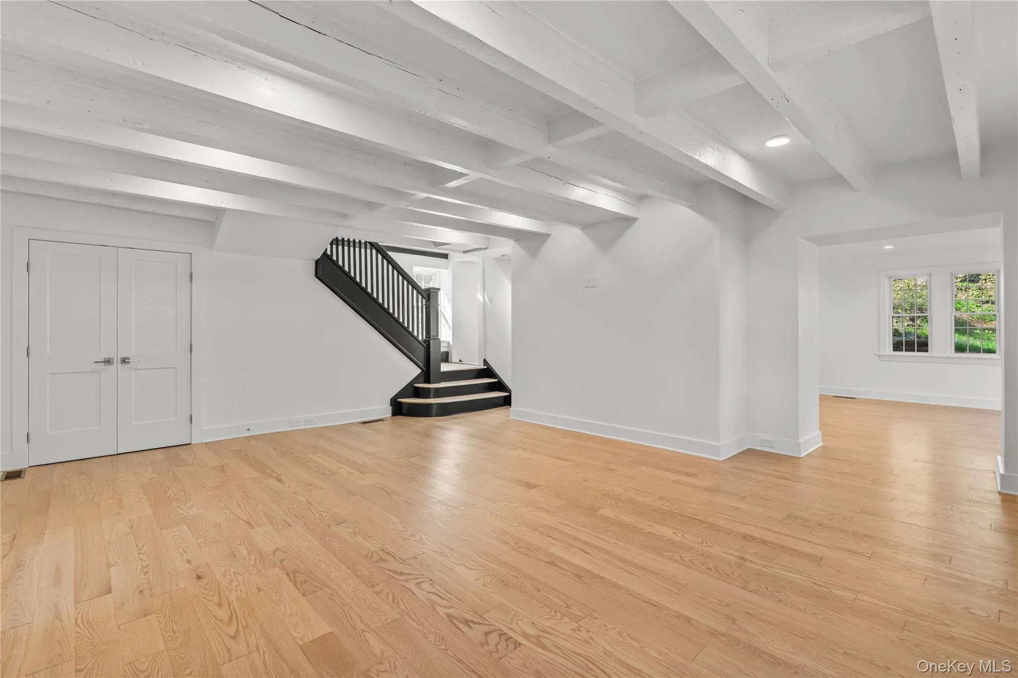 Living room with stairs to bedrooms and open passageway to dining. Living room with stairs to bedrooms and open passageway to dining.