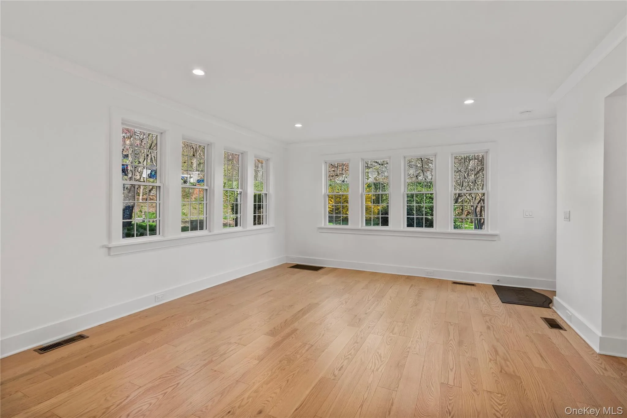 Dining area surrounded by windows on three sides. Dining area surrounded by windows on three sides.
