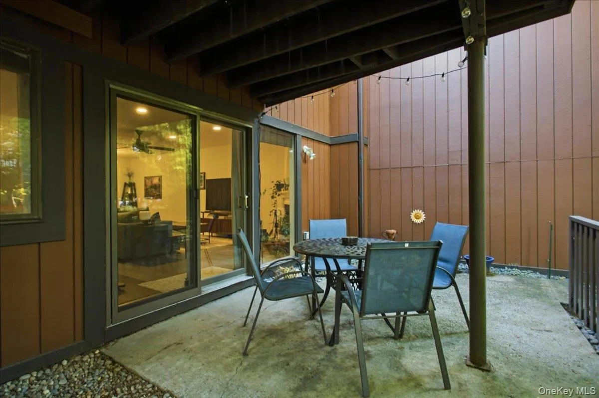 View of the large patio. A fence and mature trees add privacy. View of the large patio. A fence and mature trees add privacy.
