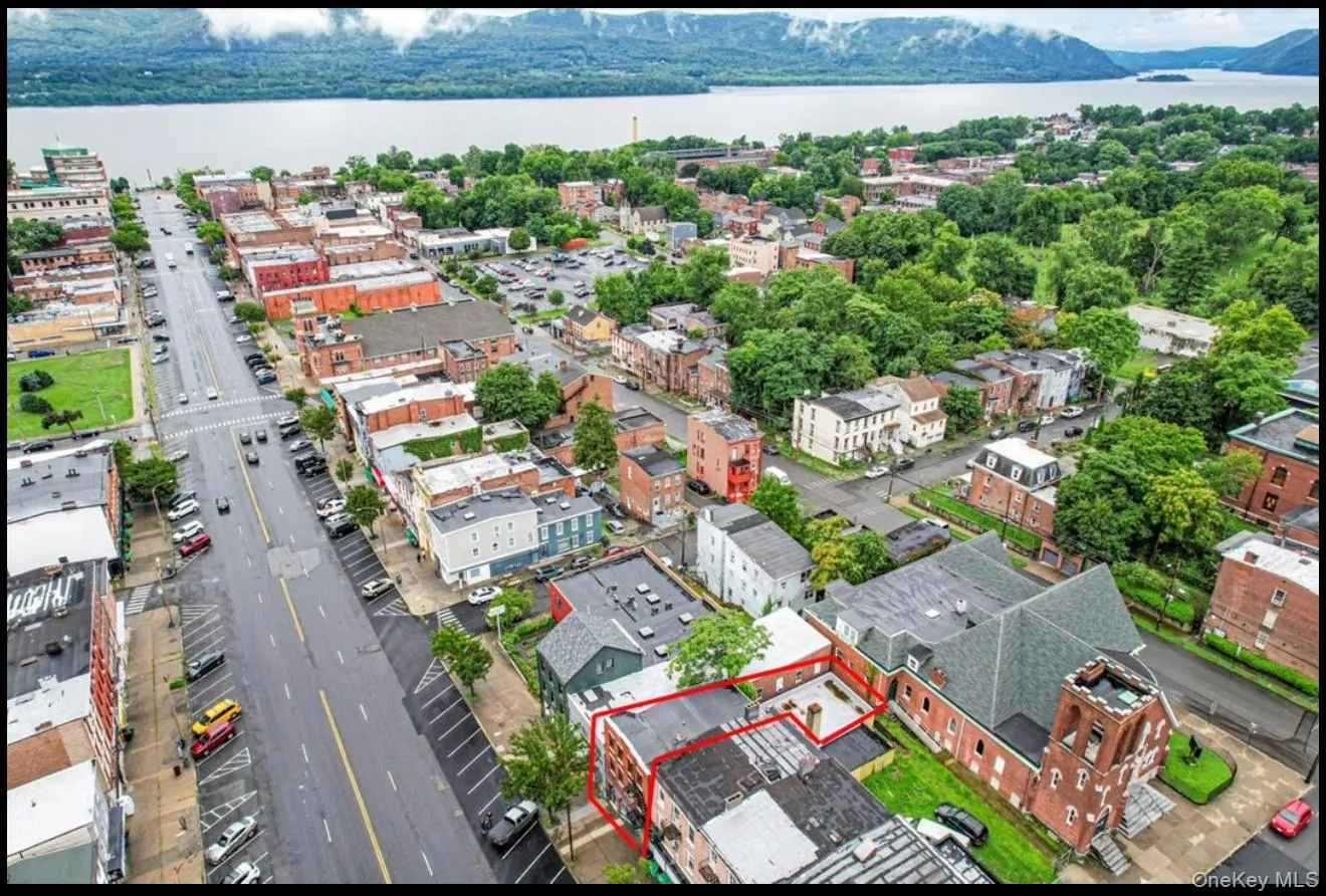 Aerial overview of property's location featuring property parcel outlined and a large body of water Aerial overview of property's location featuring property parcel outlined and a large body of water