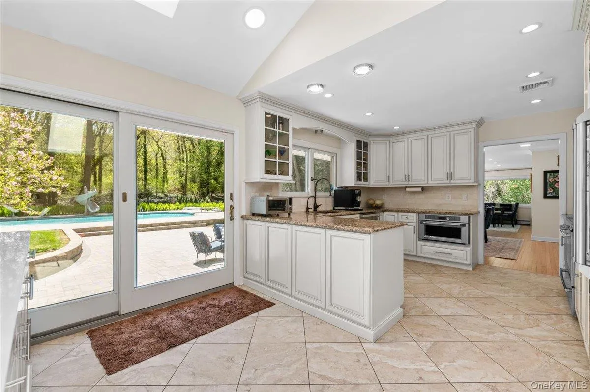 Open Kitchen with glass doors to massive patio and sparkling pool Open Kitchen with glass doors to massive patio and sparkling pool