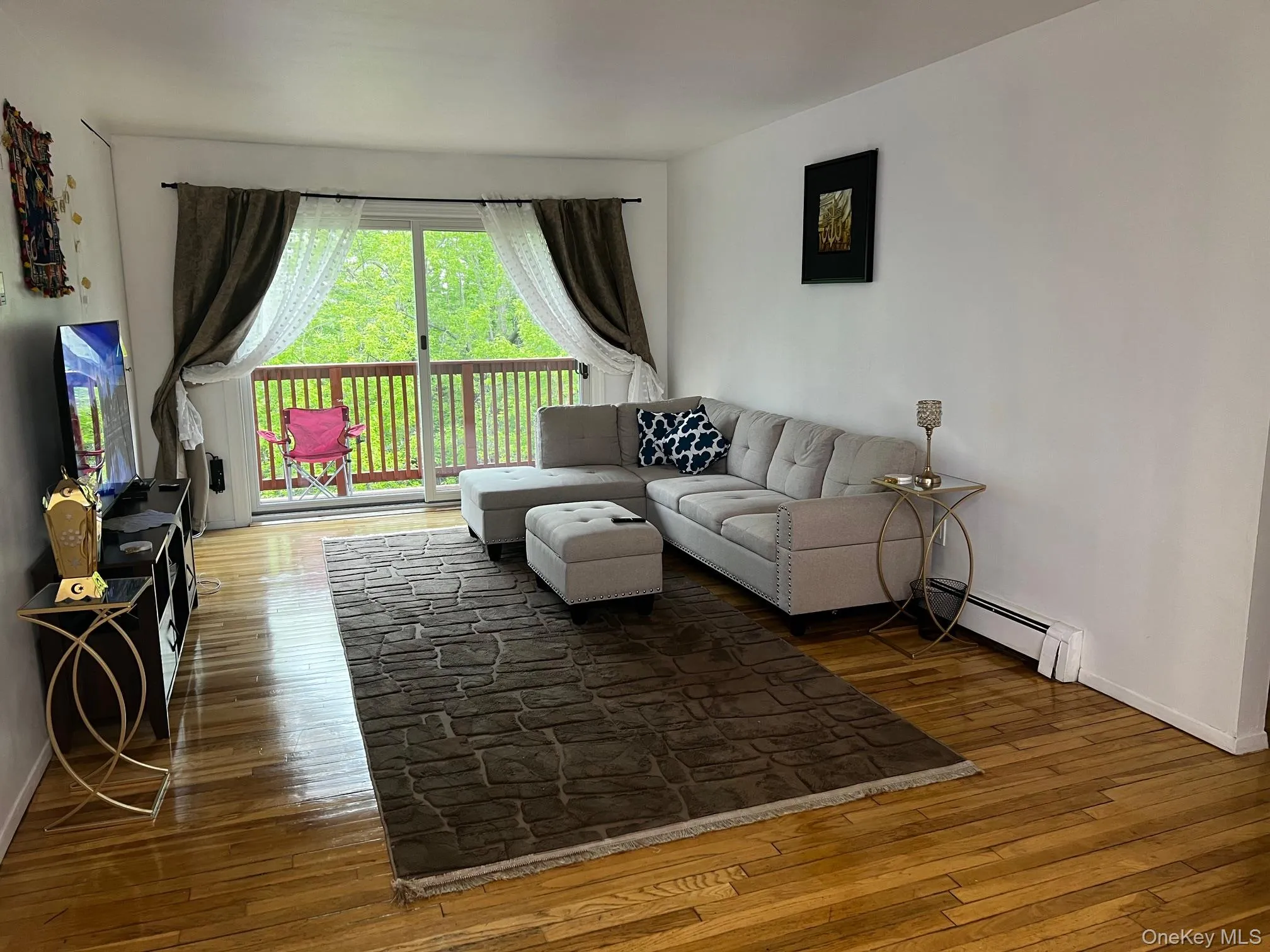 Living Room with Sliders to deck and gleaming hardwood floors Living Room with Sliders to deck and gleaming hardwood floors