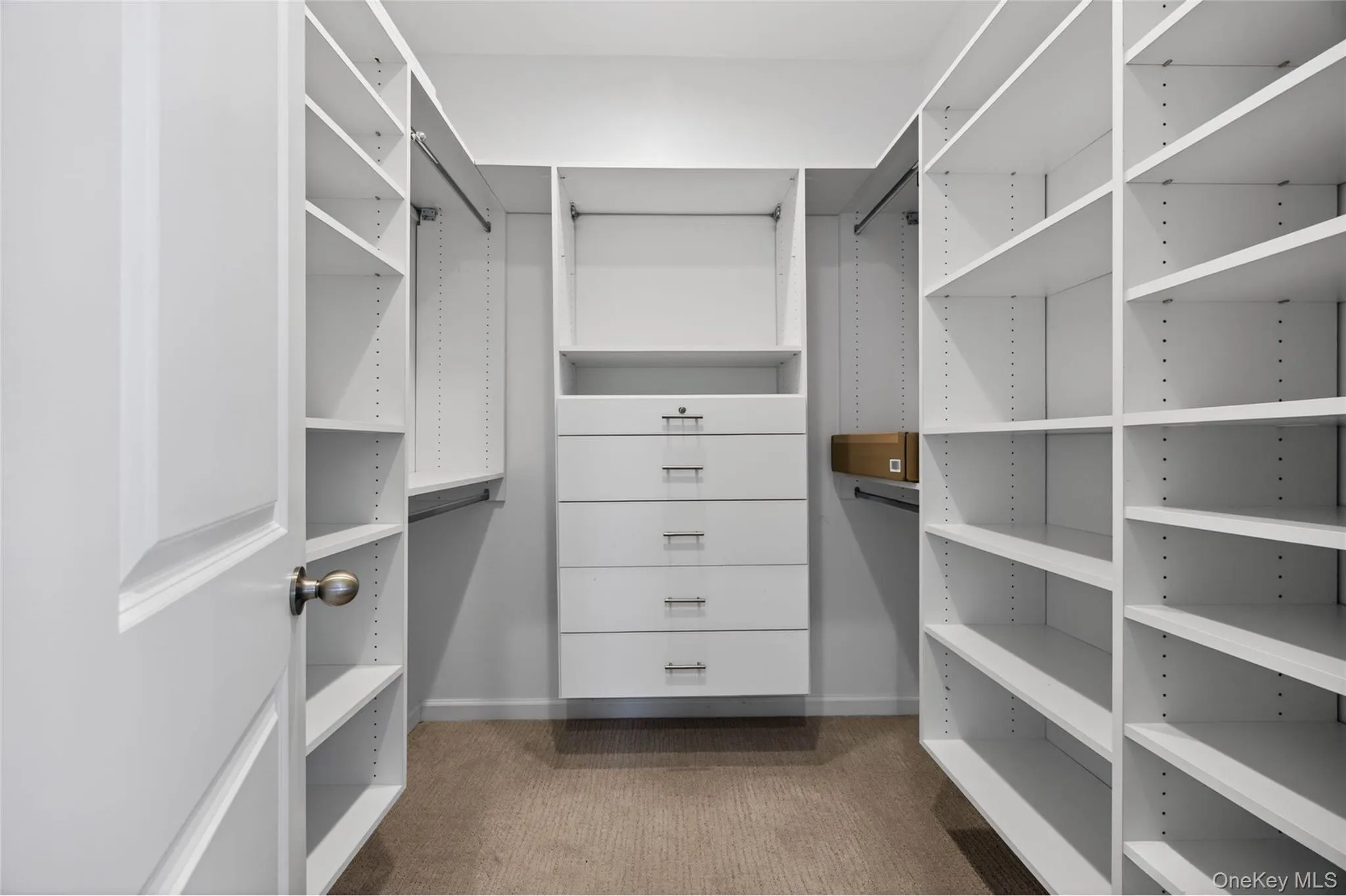 Primary bedroom walk-in closet Primary bedroom walk-in closet