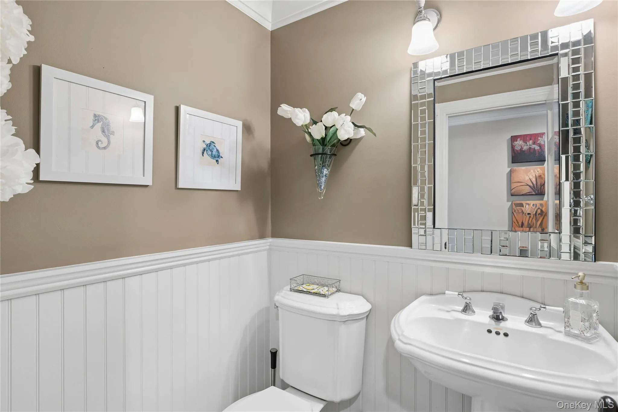Powder room w/Pedestal sink with chrome fixtures, complemented by white wainscoting Powder room w/Pedestal sink with chrome fixtures, complemented by white wainscoting