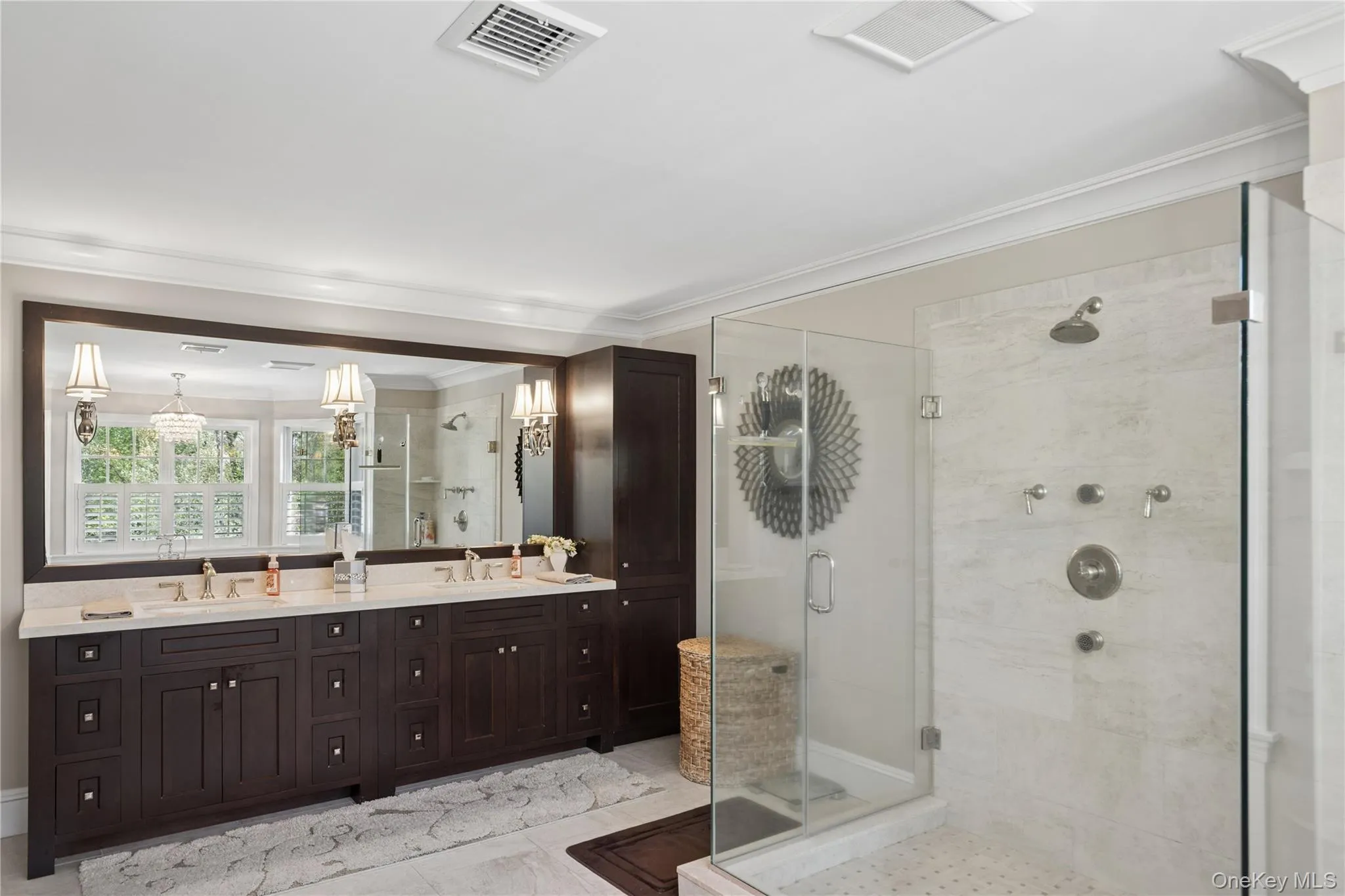 Spacious bathroom featuring a dual vanity with dark wood cabinetry and walk in shower Spacious bathroom featuring a dual vanity with dark wood cabinetry and walk in shower