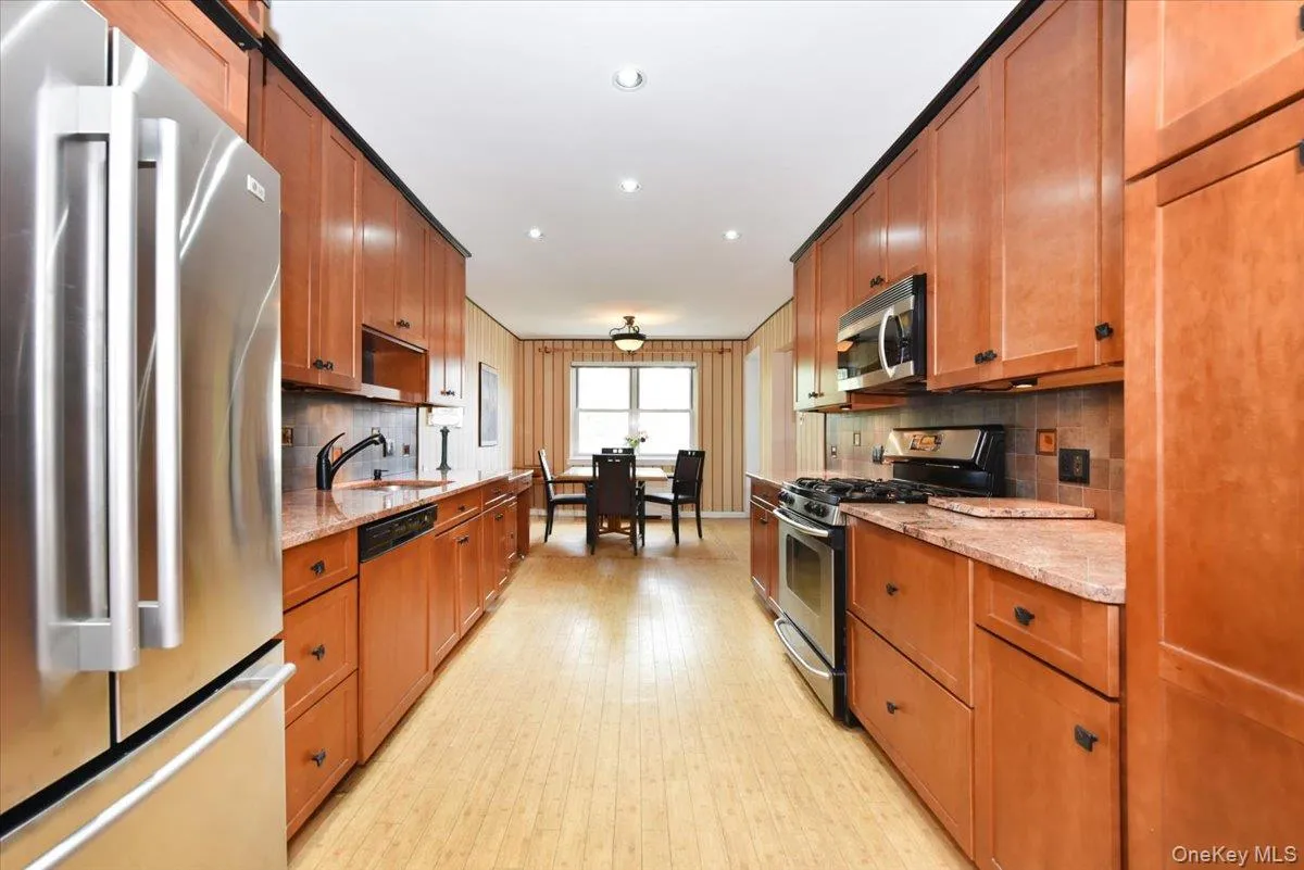 Wide Long Kitchen with granite counters + Stainless fridge Wide Long Kitchen with granite counters + Stainless fridge