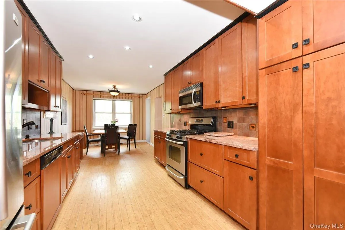 Wide Long Kitchen with granite counters + Stainless fridge Wide Long Kitchen with granite counters + Stainless fridge