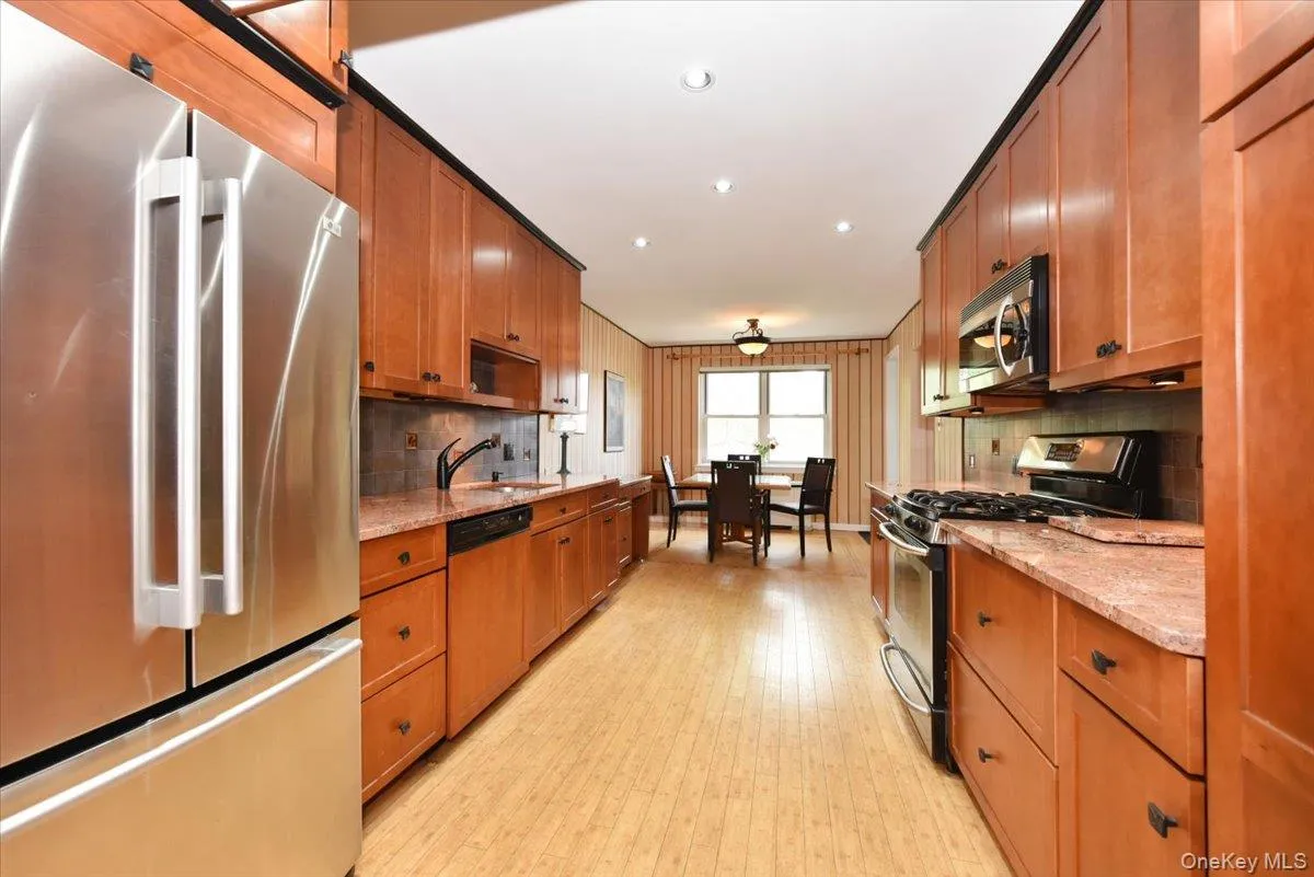 Wide Long Kitchen with granite counters + Stainless fridge Wide Long Kitchen with granite counters + Stainless fridge