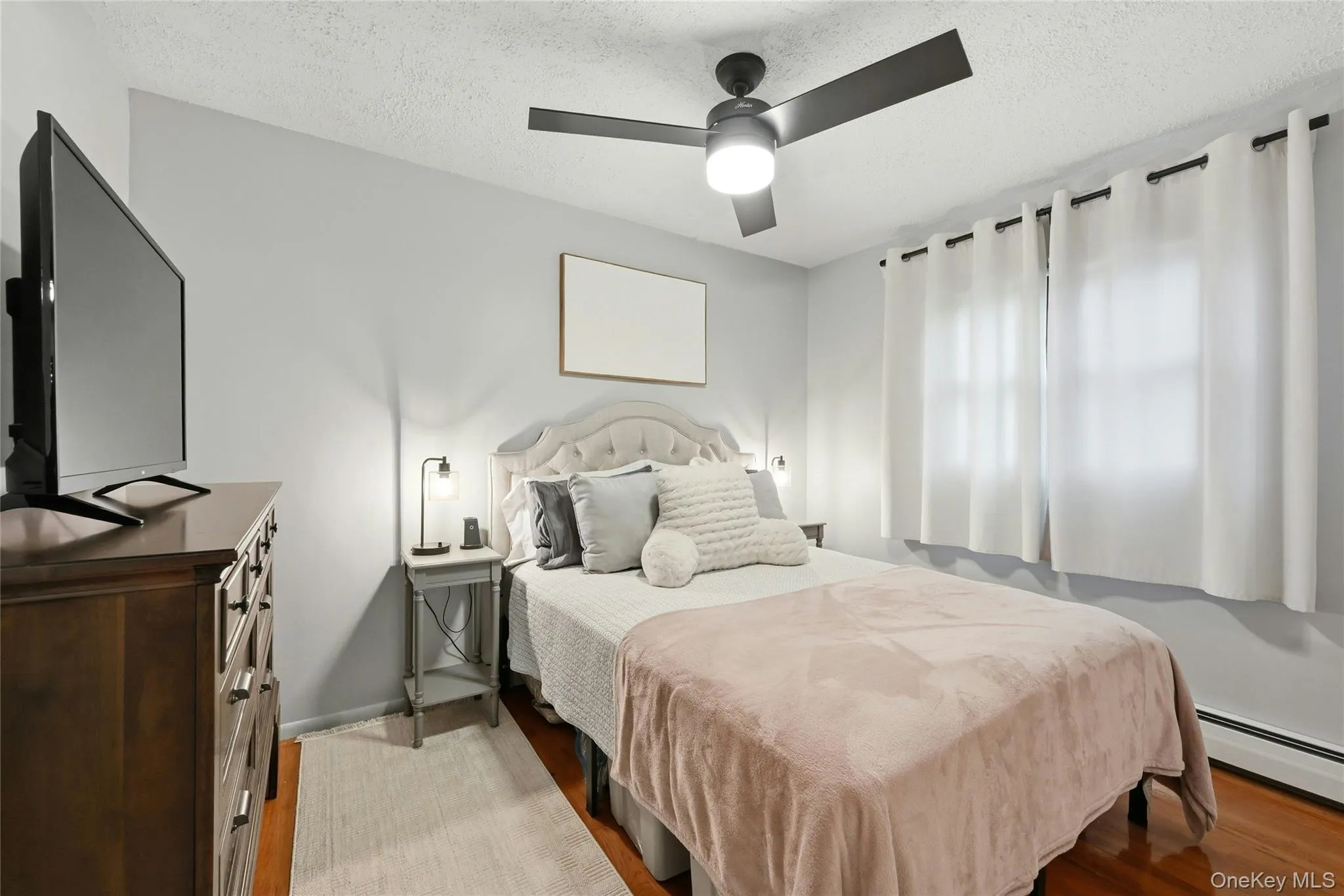 The Well Sized Second Bedroom Offers A Double Window For Natural Light, Hardwood Floors, Ceiling Fan, Good Sized Closet & Ample Room For Furniture. The Well Sized Second Bedroom Offers A Double Window For Natural Light, Hardwood Floors, Ceiling Fan, Good Sized Closet & Ample Room For Furniture.