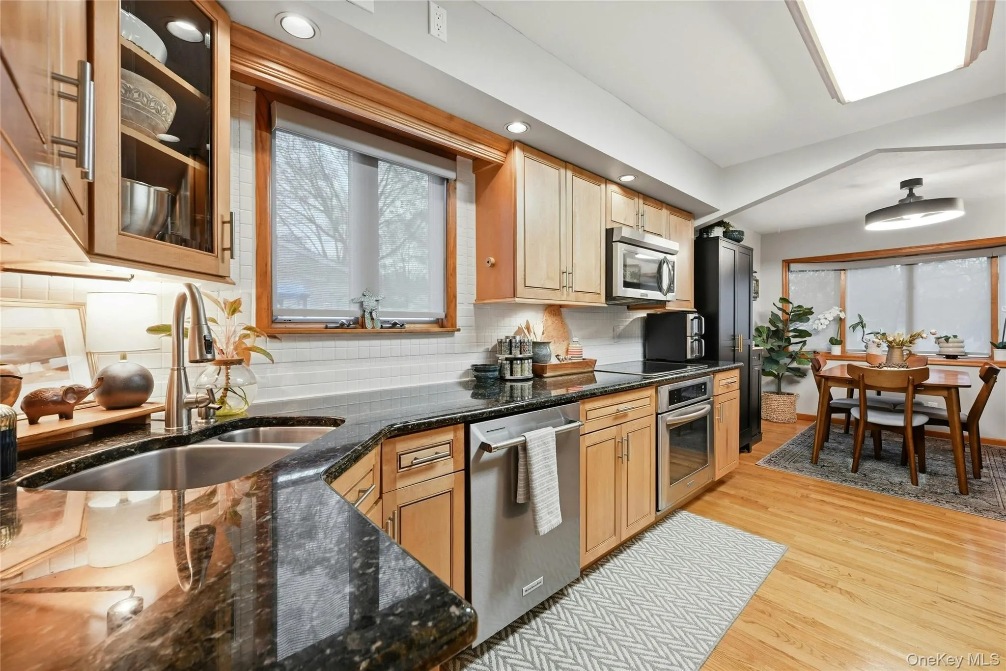 Another View Of The Beautifully Updated & Upgraded Custom Kitchen Offering Walls Of Maple Cabinetry, Granite Countertops With An Undermount Sink & Ample Counter/Serving Spaces, Tiled Backsplash, Stainless Steel Appliances, Hardwood Floors & A Separate Sun Filled Dinette Area. Another View Of The Beautifully Updated & Upgraded Custom Kitchen Offering Walls Of Maple Cabinetry, Granite Countertops With An Undermount Sink & Ample Counter/Serving Spaces, Tiled Backsplash, Stainless Steel Appliances, Hardwood Floors & A Separate Sun Filled Dinette Area.