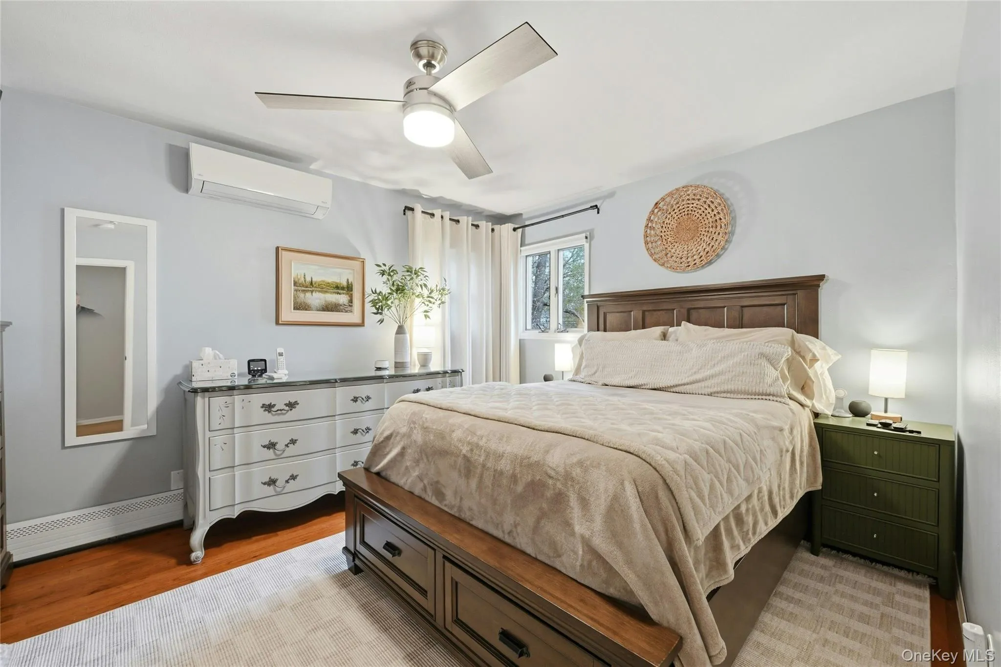 The Comfortable & Inviting Primary Bedroom Offers Two Double Corner Windows For Natural Light, Hardwood Floors, Ceiling Fan, Good Sized Closet & Ample Room For A Good Sized Bedroom Set/Furniture. The Comfortable & Inviting Primary Bedroom Offers Two Double Corner Windows For Natural Light, Hardwood Floors, Ceiling Fan, Good Sized Closet & Ample Room For A Good Sized Bedroom Set/Furniture.