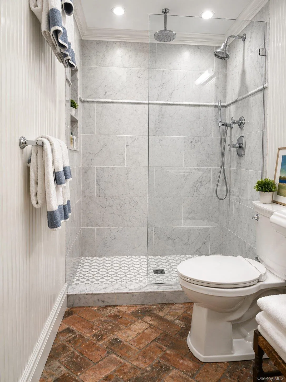 Lower-level bathroom with glass-enclosed shower, adding functionality to the finished space. Lower-level bathroom with glass-enclosed shower, adding functionality to the finished space.