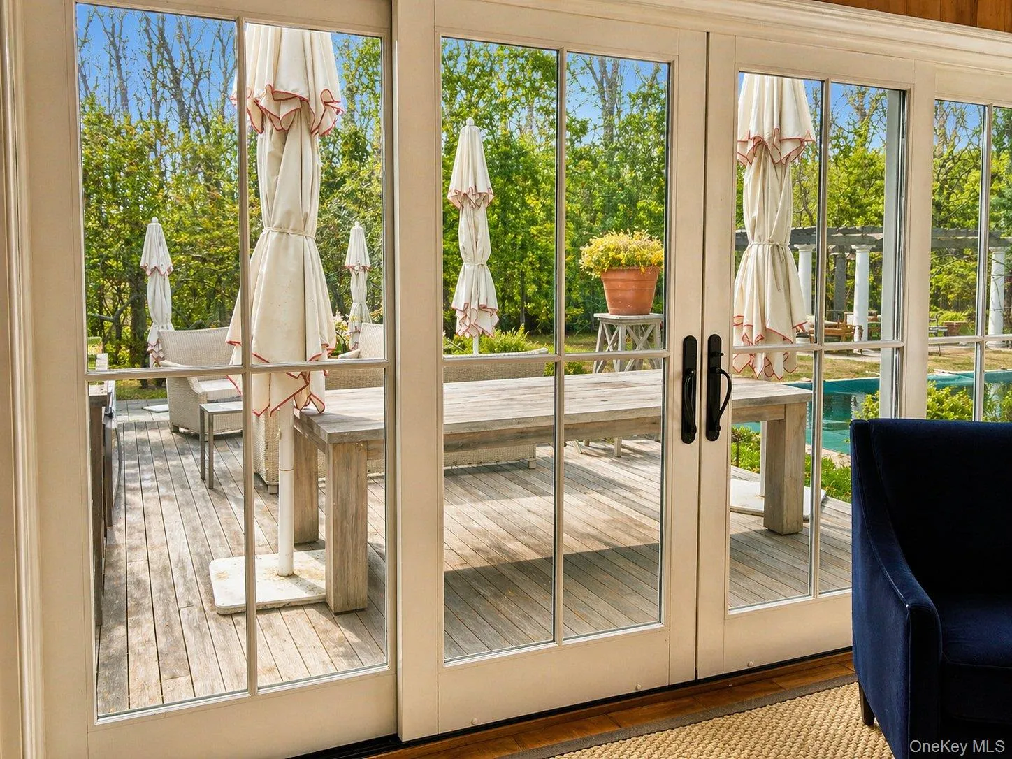 French doors connect the sunroom directly to the deck, pool and outdoor living areas. French doors connect the sunroom directly to the deck, pool and outdoor living areas.