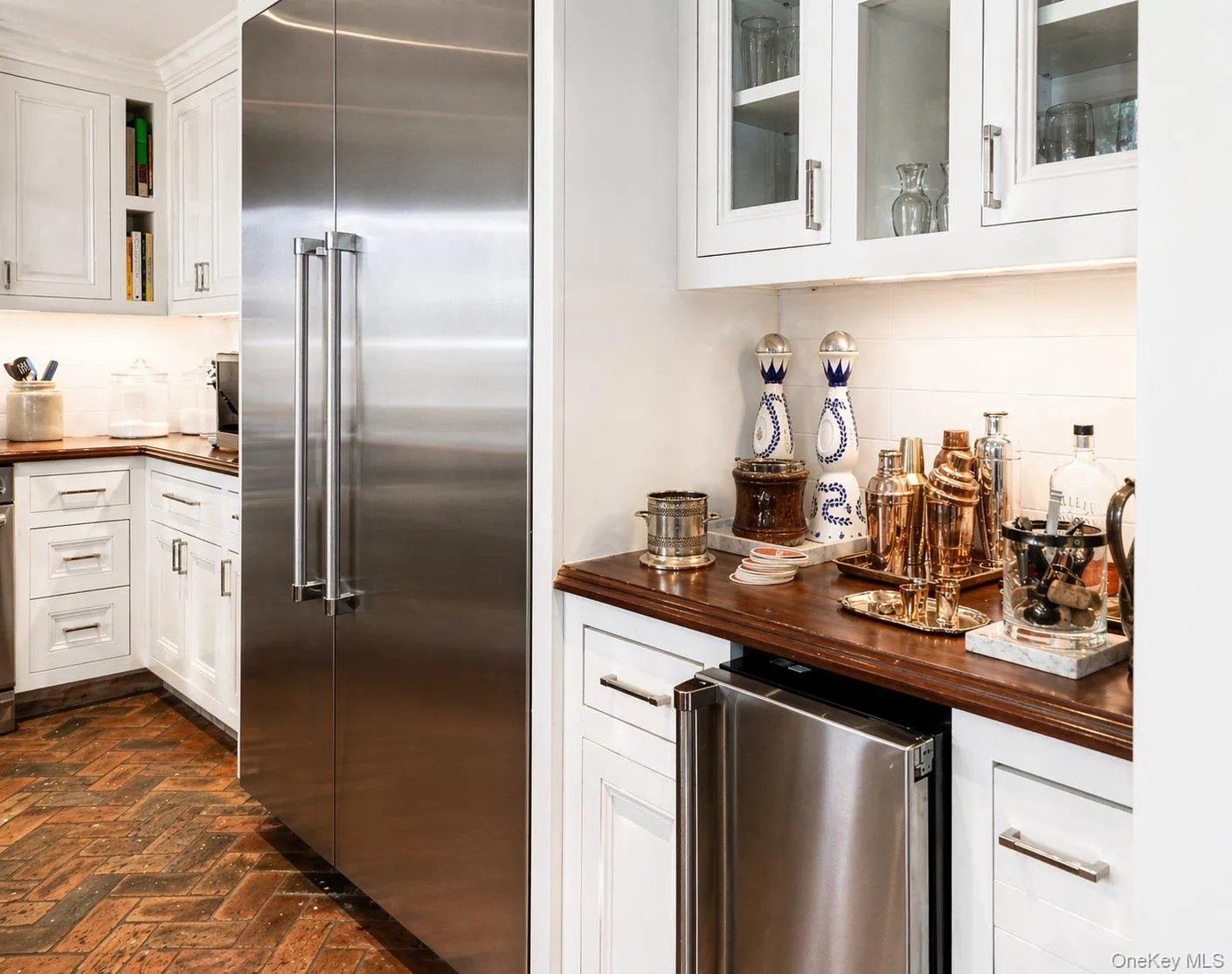 Kitchen beverage and storage area with wine refrigerator and additional cabinetry. Kitchen beverage and storage area with wine refrigerator and additional cabinetry.