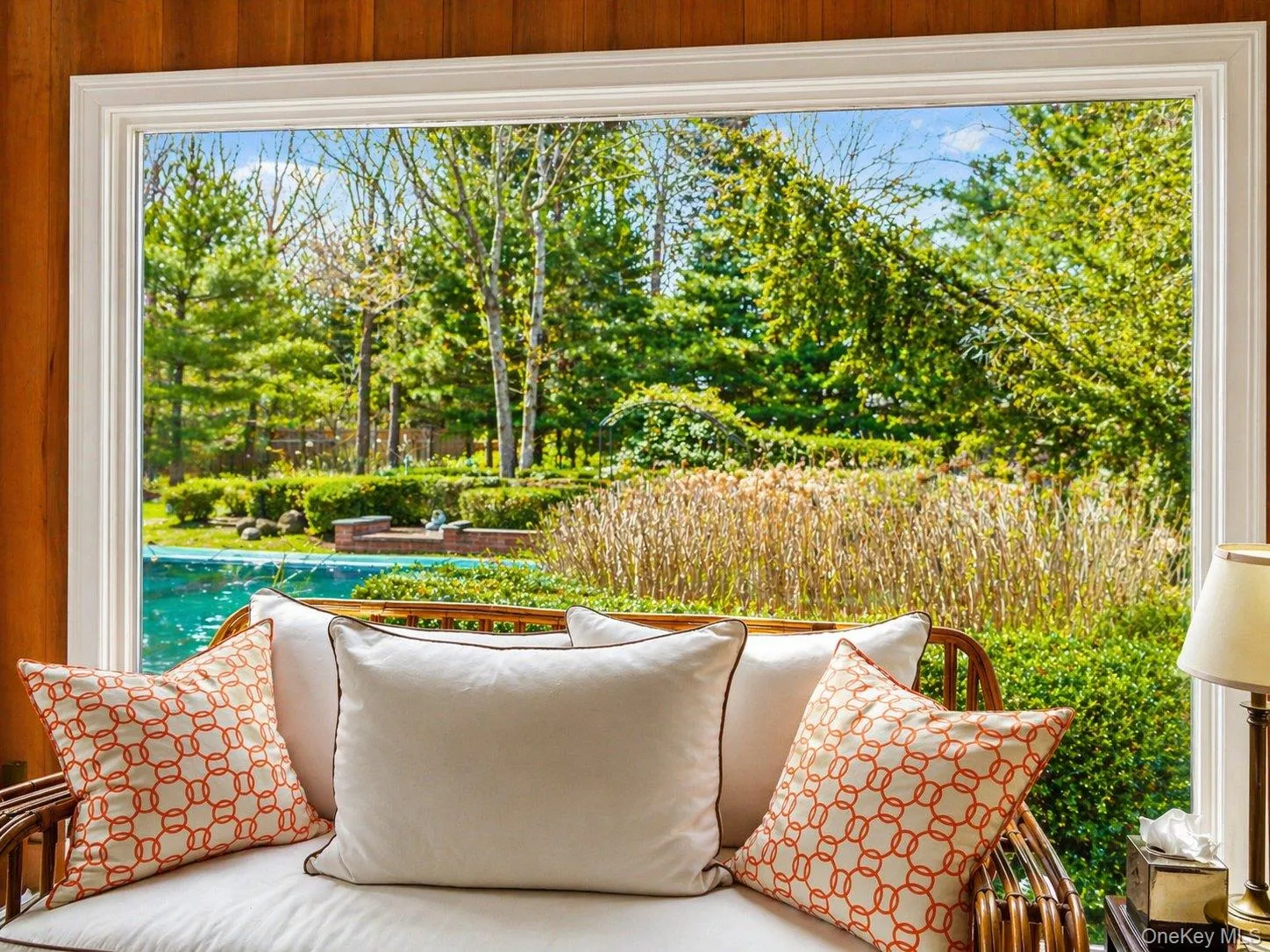 Sunroom overlooking the pool and landscaped backyard through an expansive picture window. Sunroom overlooking the pool and landscaped backyard through an expansive picture window.