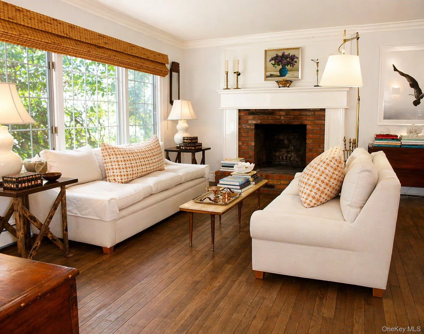 Living room with hardwood floors, abundant natural light and a wood-burning fireplace. Living room with hardwood floors, abundant natural light and a wood-burning fireplace.