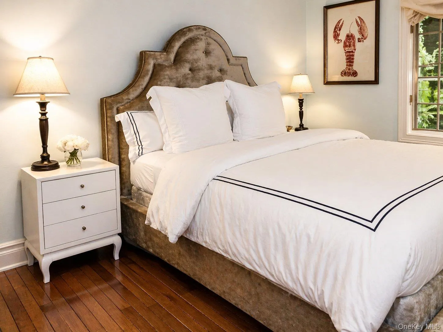 Bright bedroom with hardwood floors, windows on two exposures and a serene neutral palette. Bright bedroom with hardwood floors, windows on two exposures and a serene neutral palette.