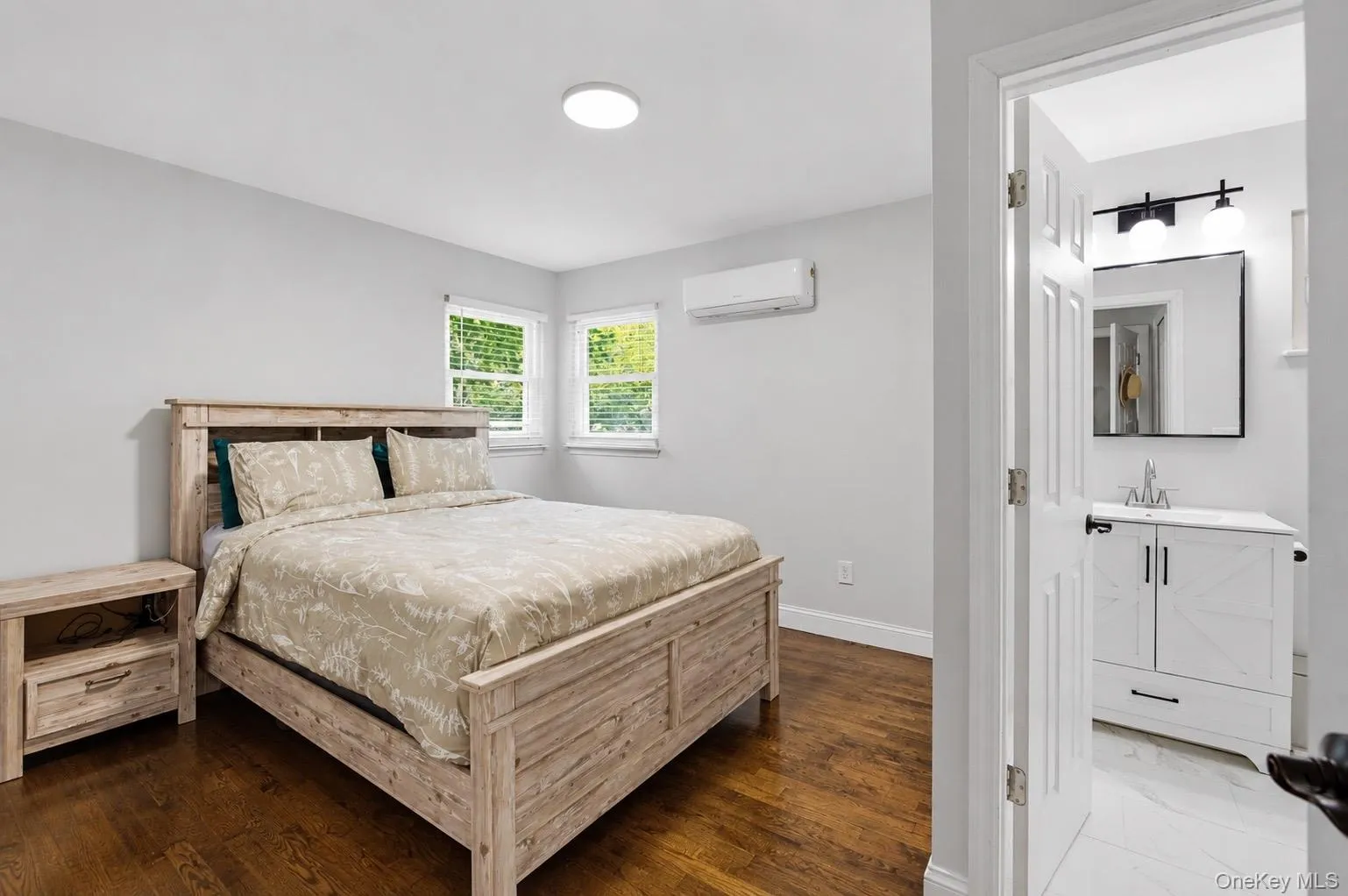 Primary bedroom with hardwood floors, ensuite bathroom and walk in closet Primary bedroom with hardwood floors, ensuite bathroom and walk in closet
