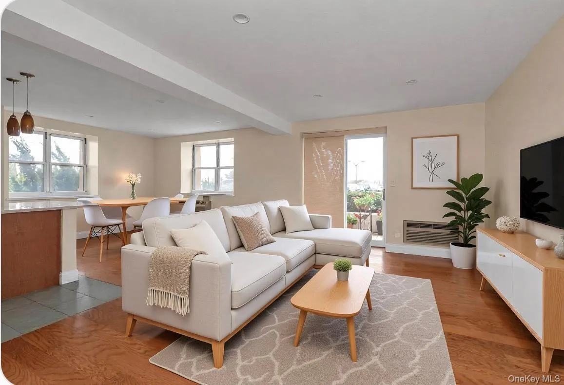 Open-concept living area featuring wood-finish flooring and neutral wall tones Open-concept living area featuring wood-finish flooring and neutral wall tones