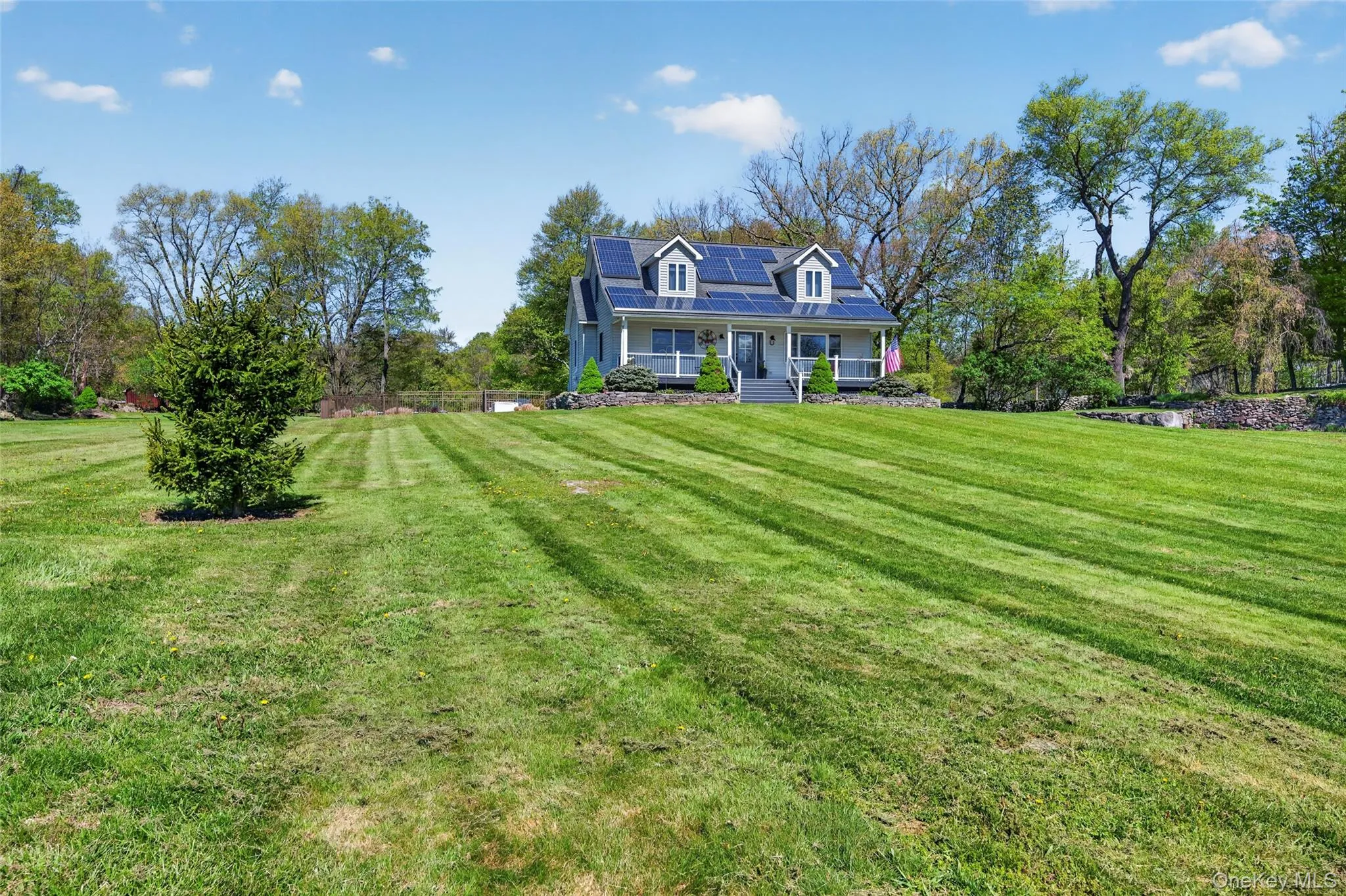 An expansive front lawn leads to a impeccably maintained cape cod An expansive front lawn leads to a impeccably maintained cape cod
