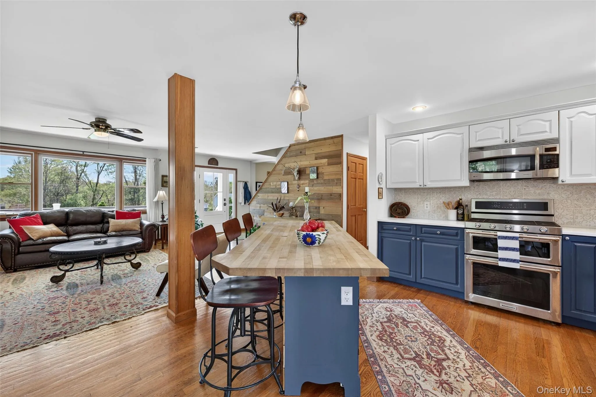 The kitchen is open to the living room, defined by a butcher block island The kitchen is open to the living room, defined by a butcher block island