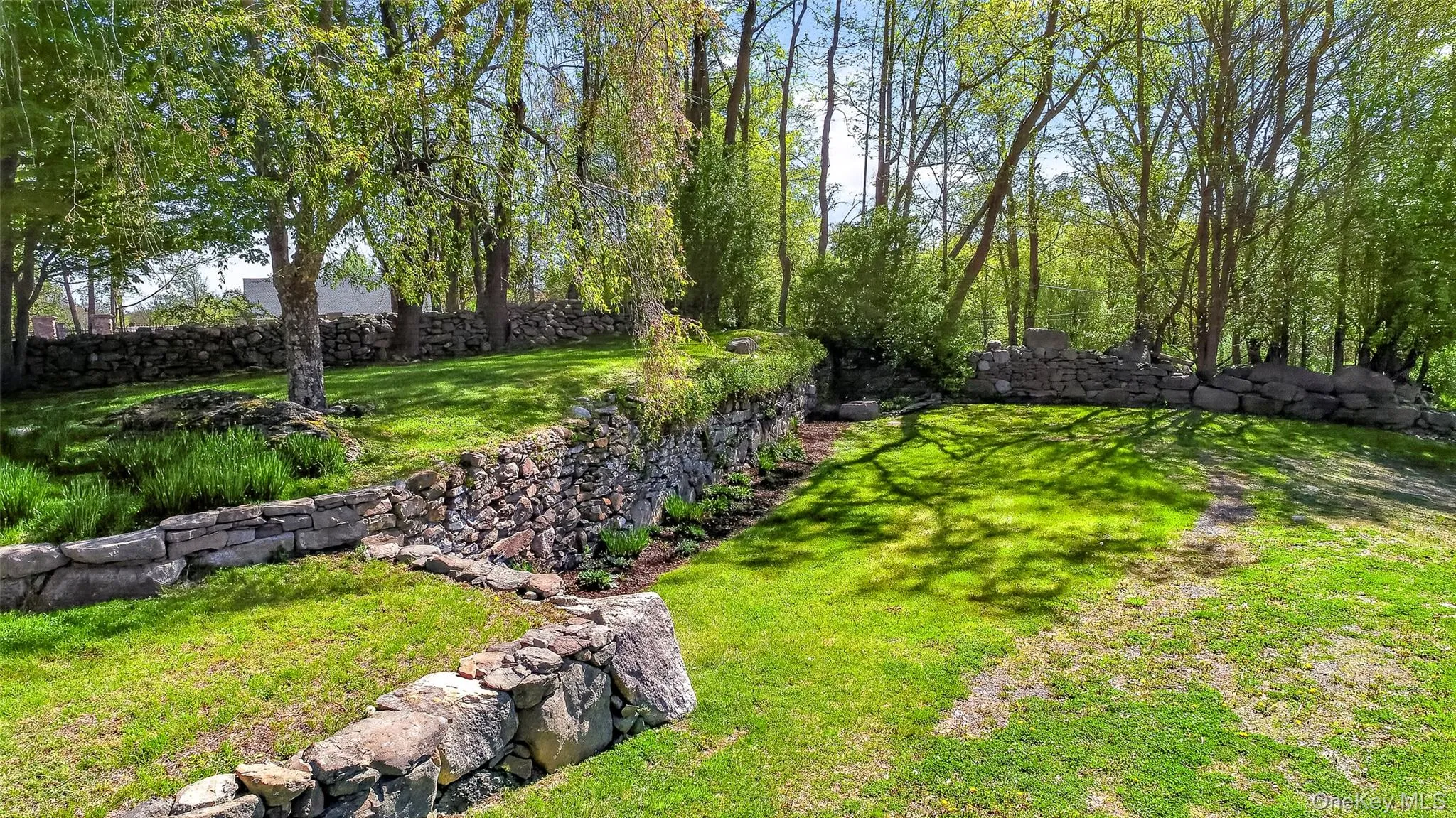 Rock walls, mature perennials and ornamental trees give this property so much character Rock walls, mature perennials and ornamental trees give this property so much character