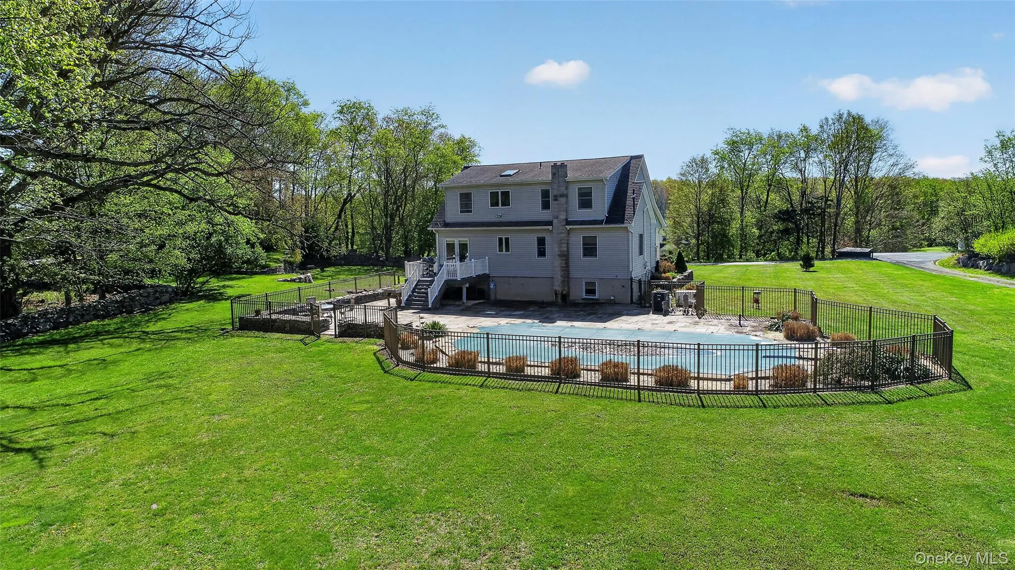 Surrounded by a classic fence and tall grasses, the pool area is ground zero for summer fun! Surrounded by a classic fence and tall grasses, the pool area is ground zero for summer fun!