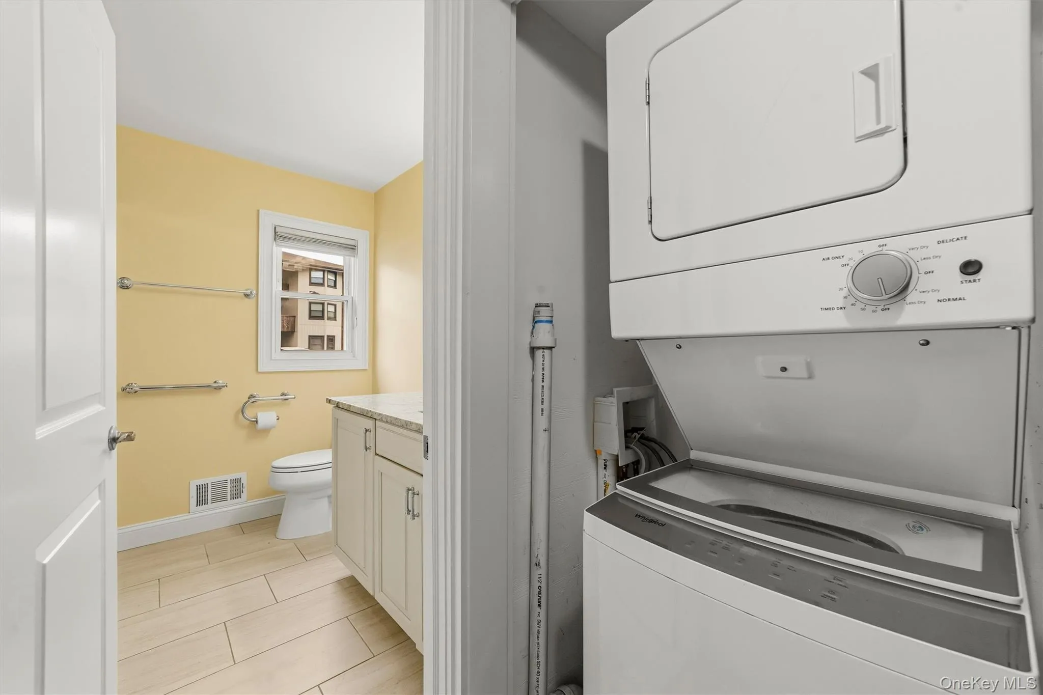 Washer dryer just outside of bathroom in its own closet Washer dryer just outside of bathroom in its own closet
