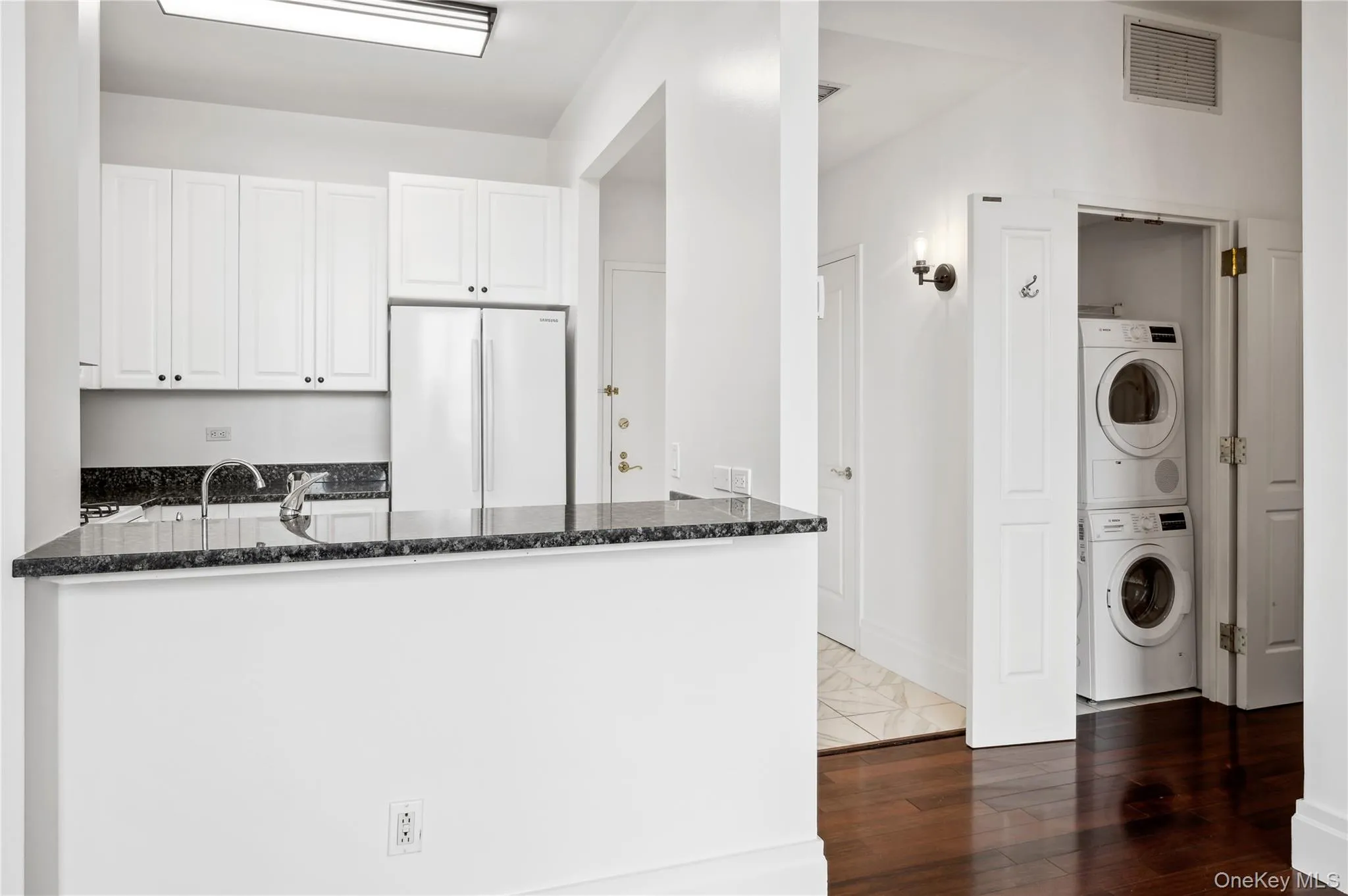 Bosch stackable washer and dryer off kitchen. Bosch stackable washer and dryer off kitchen.