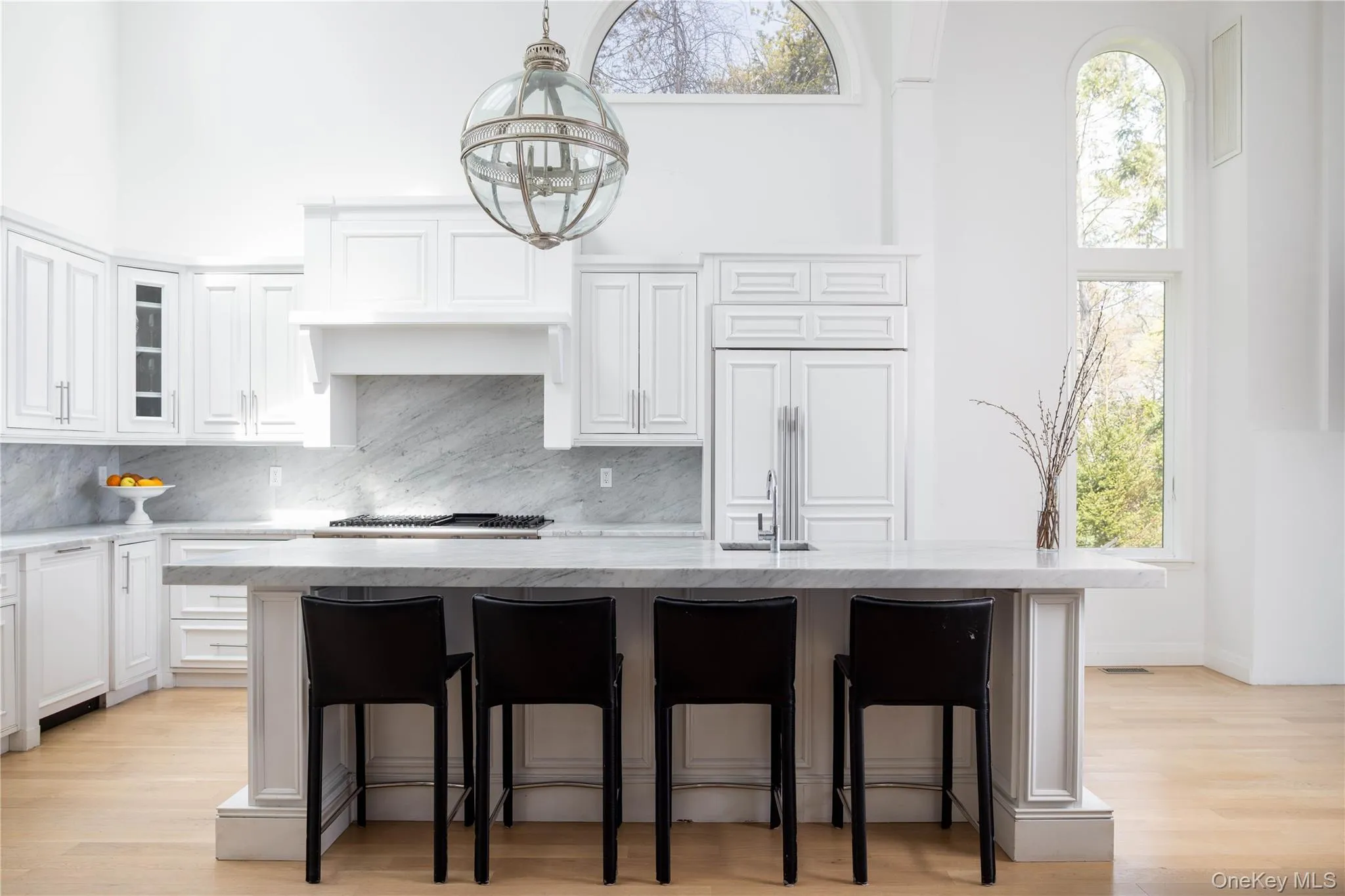 All white kitchen with marble counter tops All white kitchen with marble counter tops