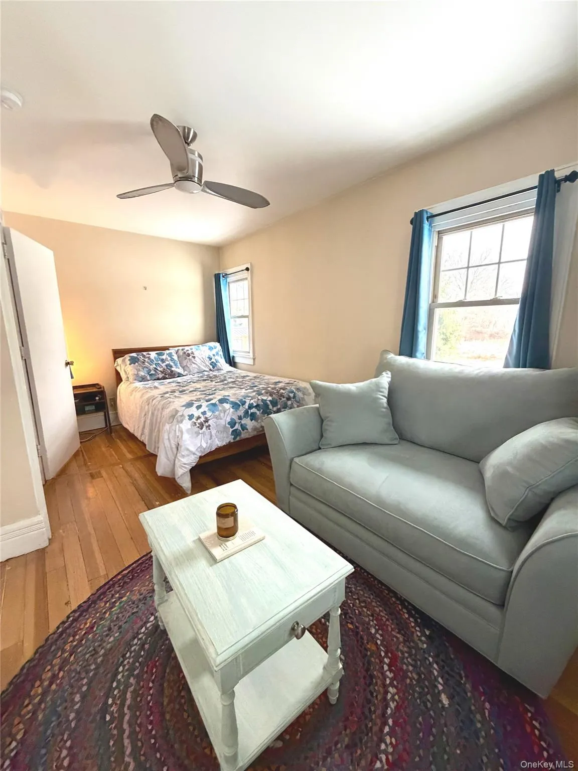 Bedroom with hardwood / wood-style flooring and a ceiling fan Bedroom with hardwood / wood-style flooring and a ceiling fan
