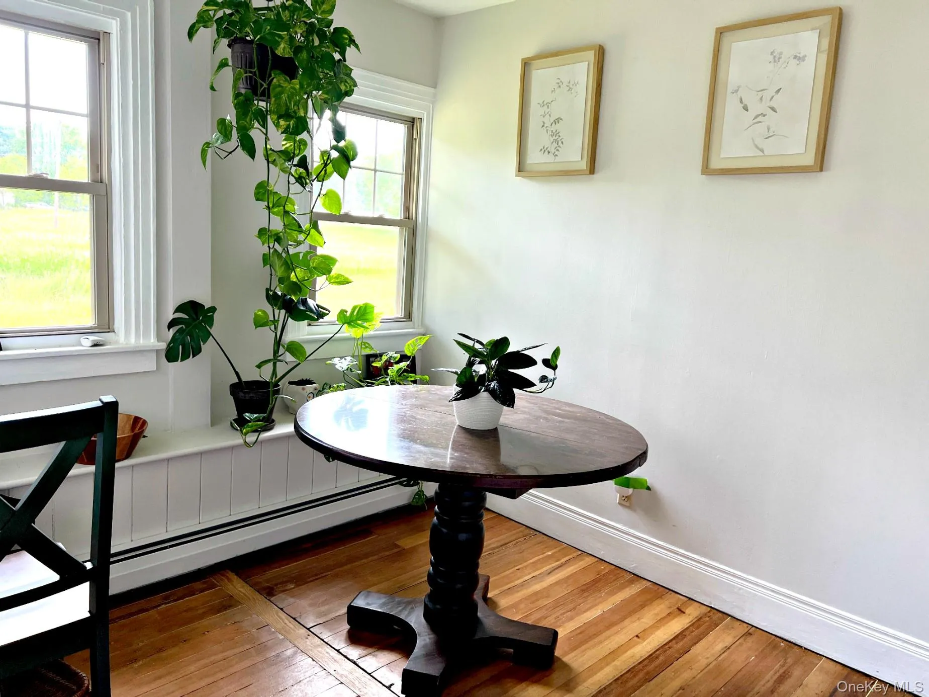 Dining area featuring hardwood / wood-style flooring and baseboards Dining area featuring hardwood / wood-style flooring and baseboards
