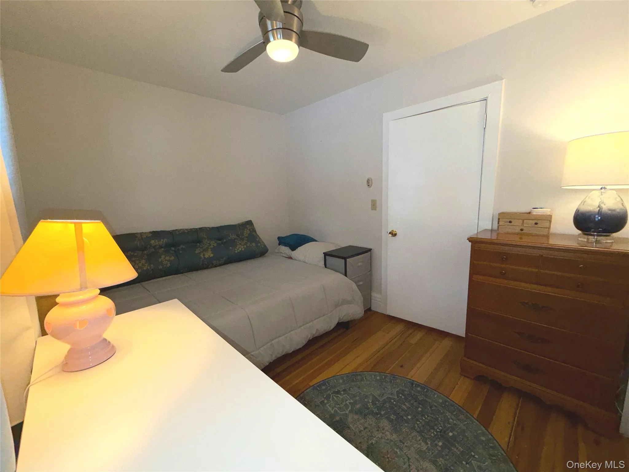 Bedroom featuring wood-type flooring and a ceiling fan Bedroom featuring wood-type flooring and a ceiling fan