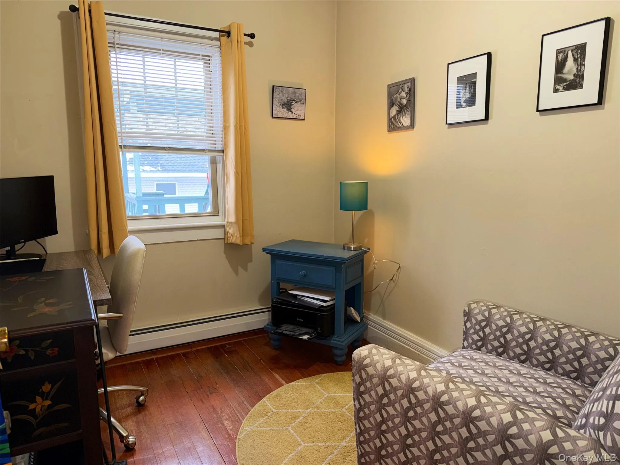 3rd Bedroom or Office featuring baseboard heating and dark wood finished floors 3rd Bedroom or Office featuring baseboard heating and dark wood finished floors