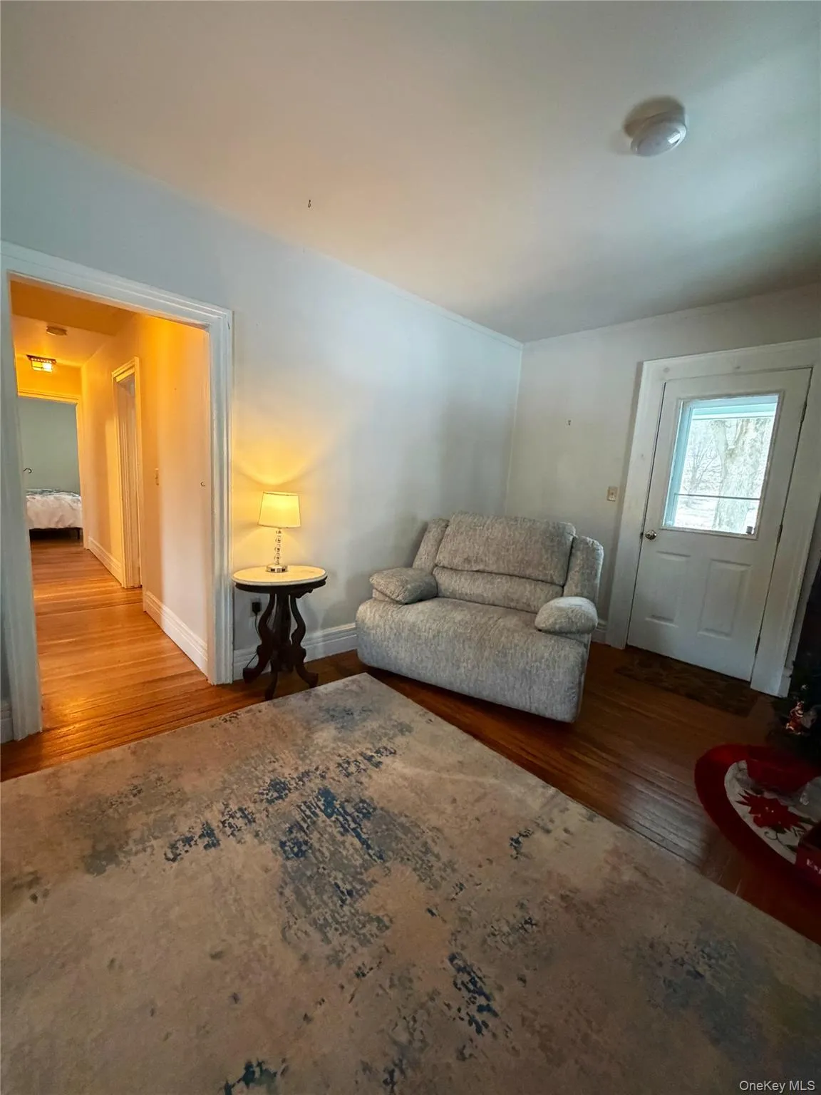 Sitting room with wood finished floors and baseboards Sitting room with wood finished floors and baseboards