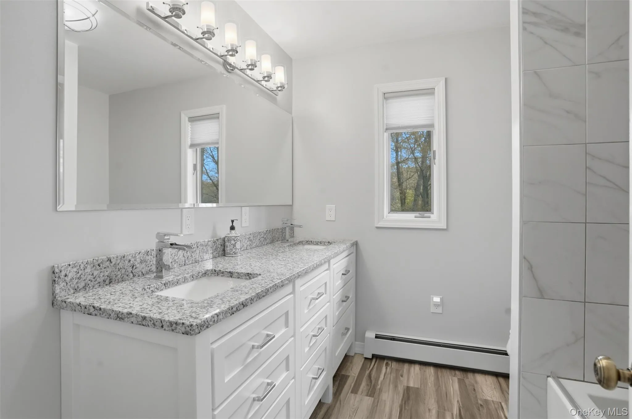 Upper-level 2nd bathroom. Double Sinks. Granite CT. tub/Shower. Tiled floors. Upper-level 2nd bathroom. Double Sinks. Granite CT. tub/Shower. Tiled floors.