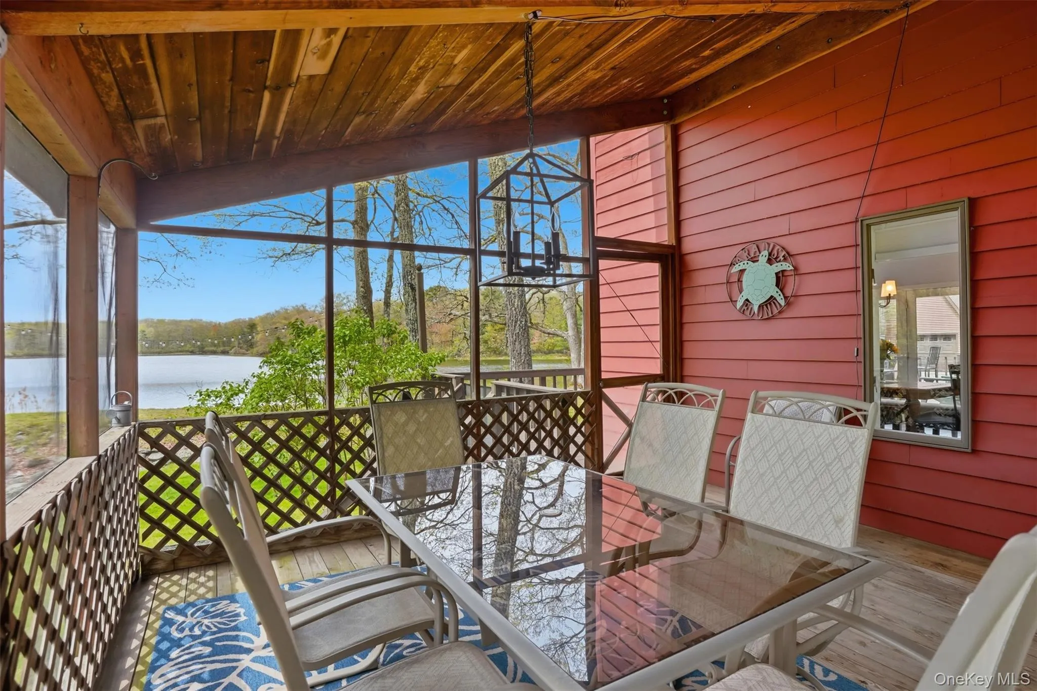 Screened in porch with a view - access from kitchen or deck overlooking lake Screened in porch with a view - access from kitchen or deck overlooking lake