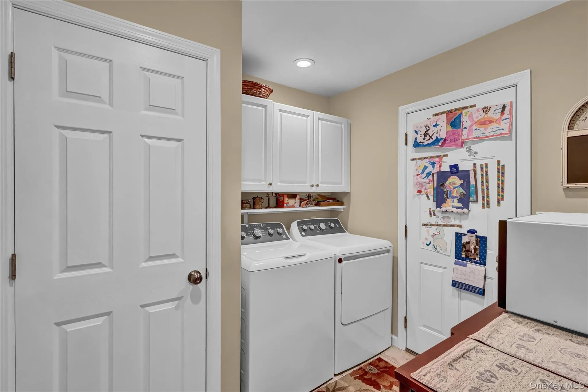 Large laundry room conveniently sits just off the kitchen with an entrance to the attached garage and a door to the backyard Large laundry room conveniently sits just off the kitchen with an entrance to the attached garage and a door to the backyard