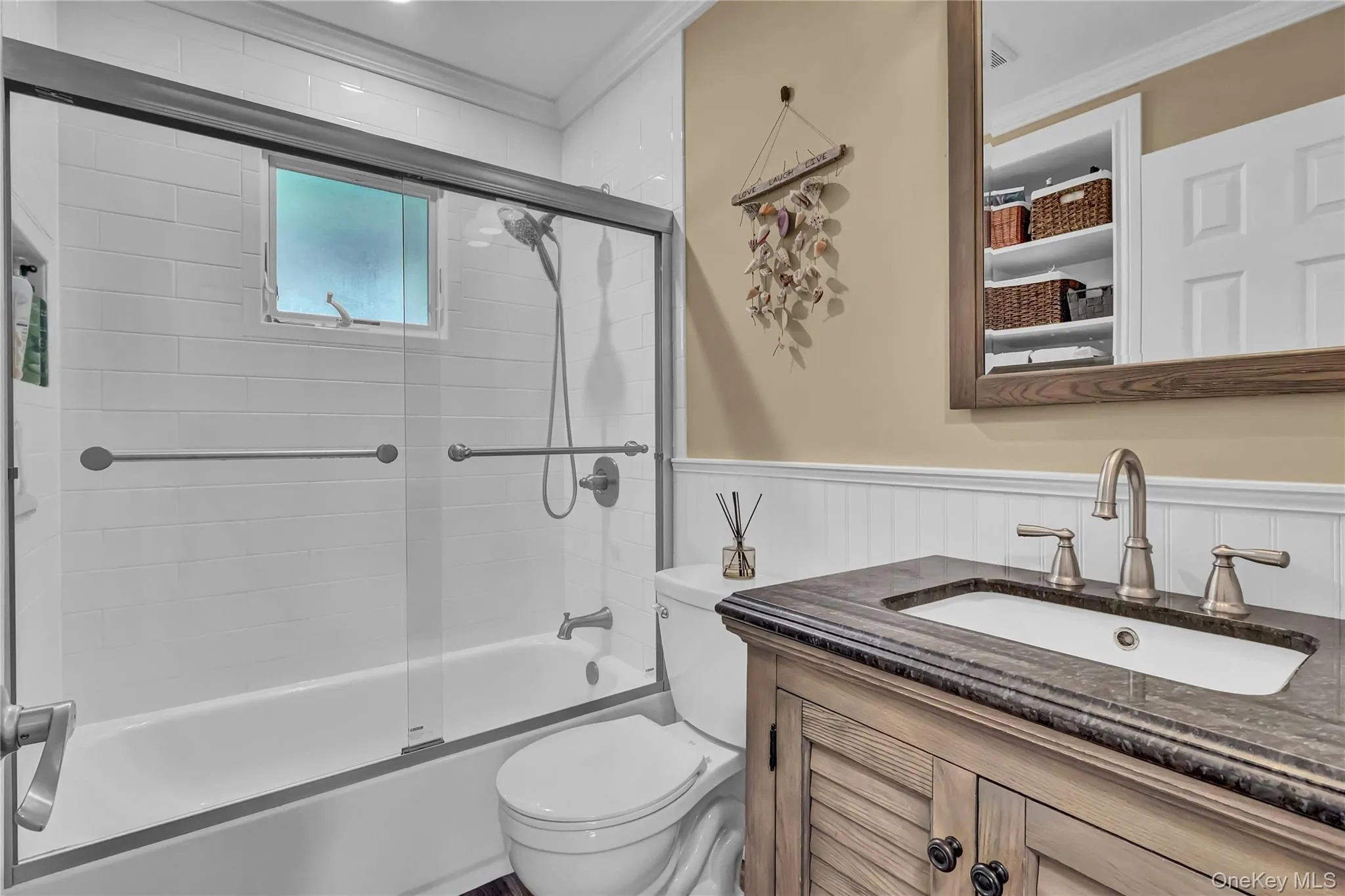 Updated bath has built in shelves and a combo shower/tub Updated bath has built in shelves and a combo shower/tub