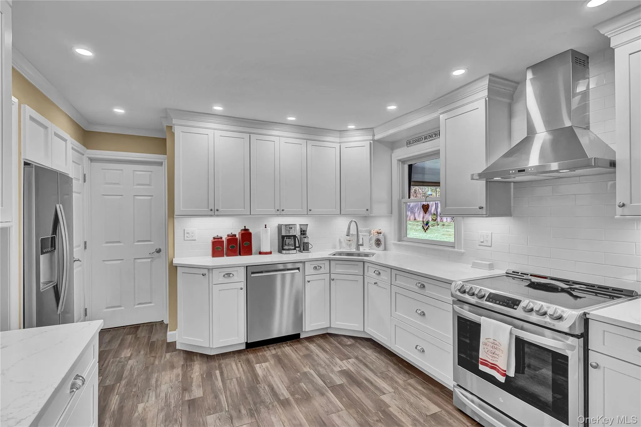 Stunning white kitchen has quartz countertops and all stainless steel appliances Stunning white kitchen has quartz countertops and all stainless steel appliances