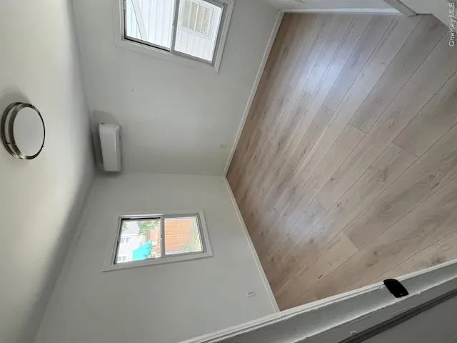 Light wood-finish flooring with white baseboards throughout Light wood-finish flooring with white baseboards throughout