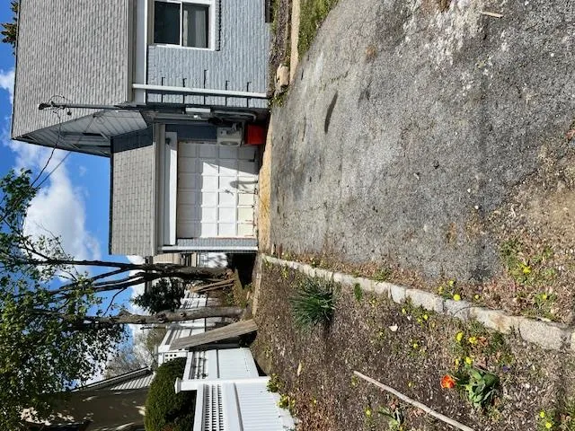 Attached garage with horizontal panel door and shingle roof Attached garage with horizontal panel door and shingle roof