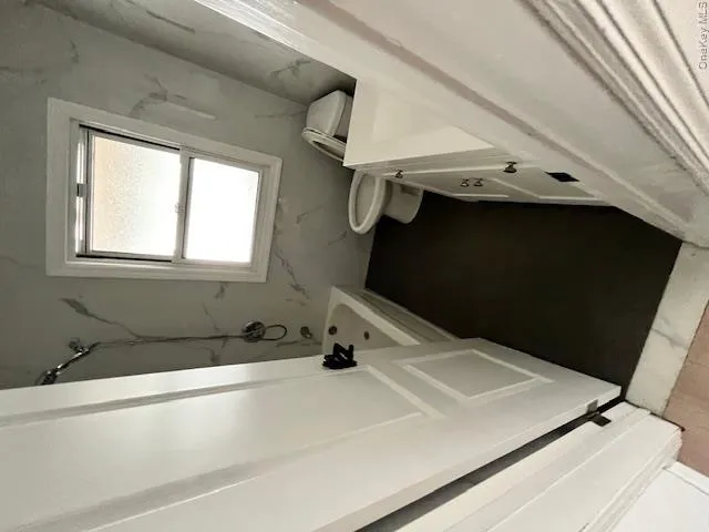 Bathroom featuring a shower-over-tub combination, a vanity with cabinet storage, and a white toilet Bathroom featuring a shower-over-tub combination, a vanity with cabinet storage, and a white toilet