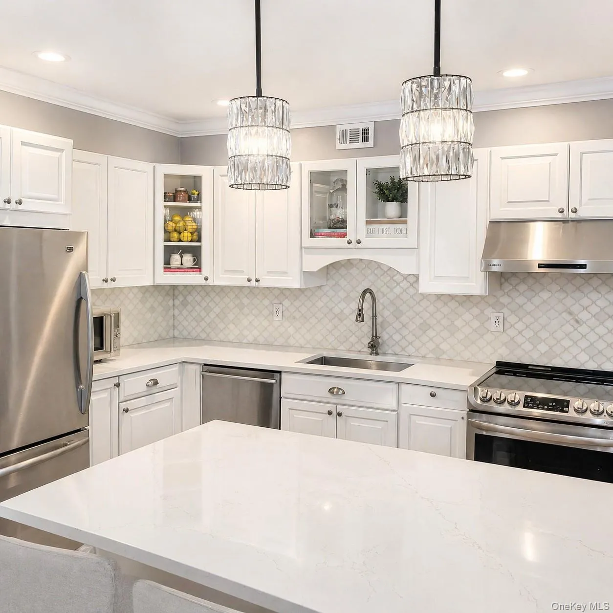 Kitchen featuring Granite countertops Granite Island and Stainless-Steel appliances Kitchen featuring Granite countertops Granite Island and Stainless-Steel appliances