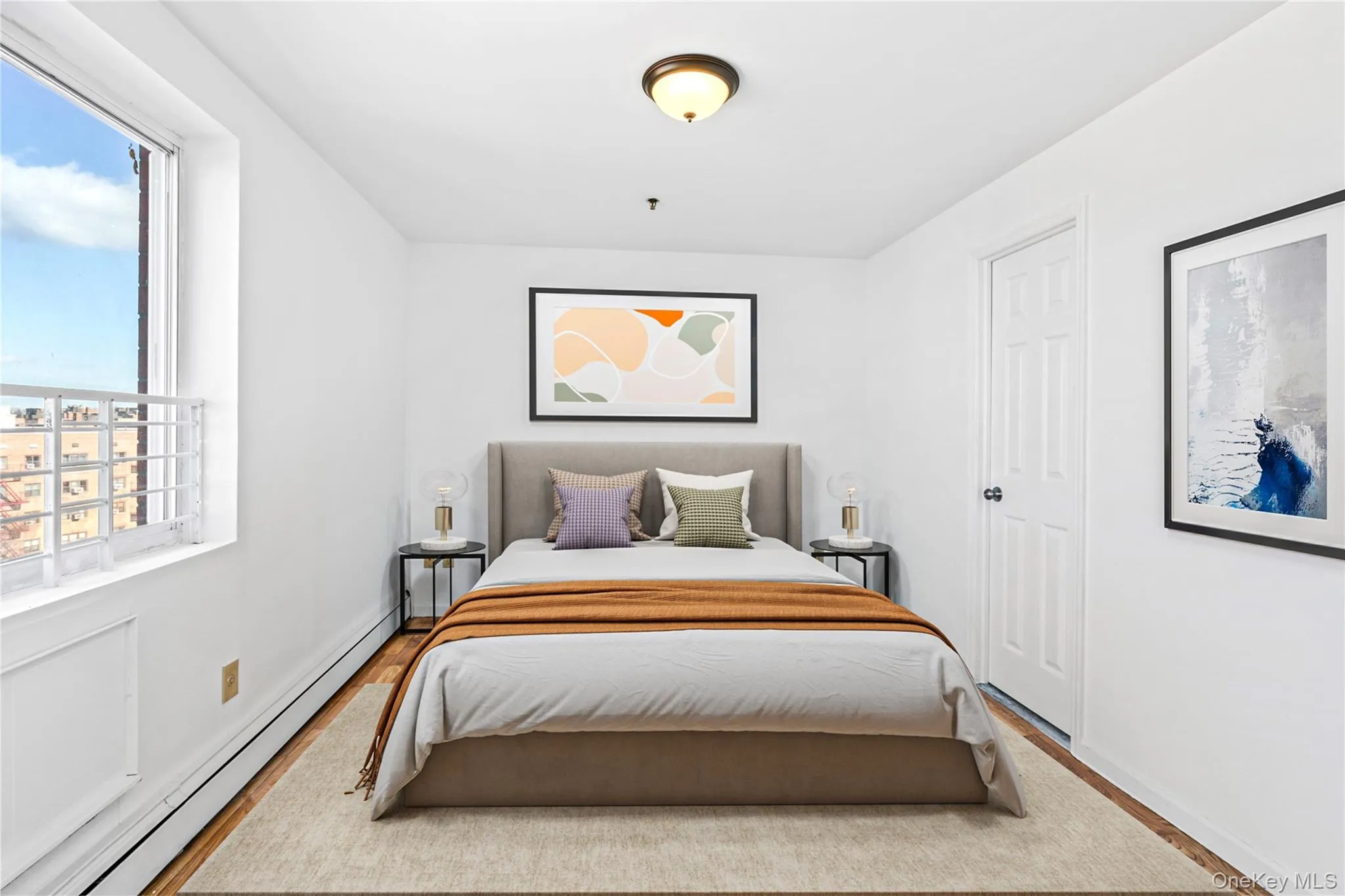 Virtual Staged Bedroom with a baseboard heating unit, multiple windows, wood finished floors, and baseboards Virtual Staged Bedroom with a baseboard heating unit, multiple windows, wood finished floors, and baseboards