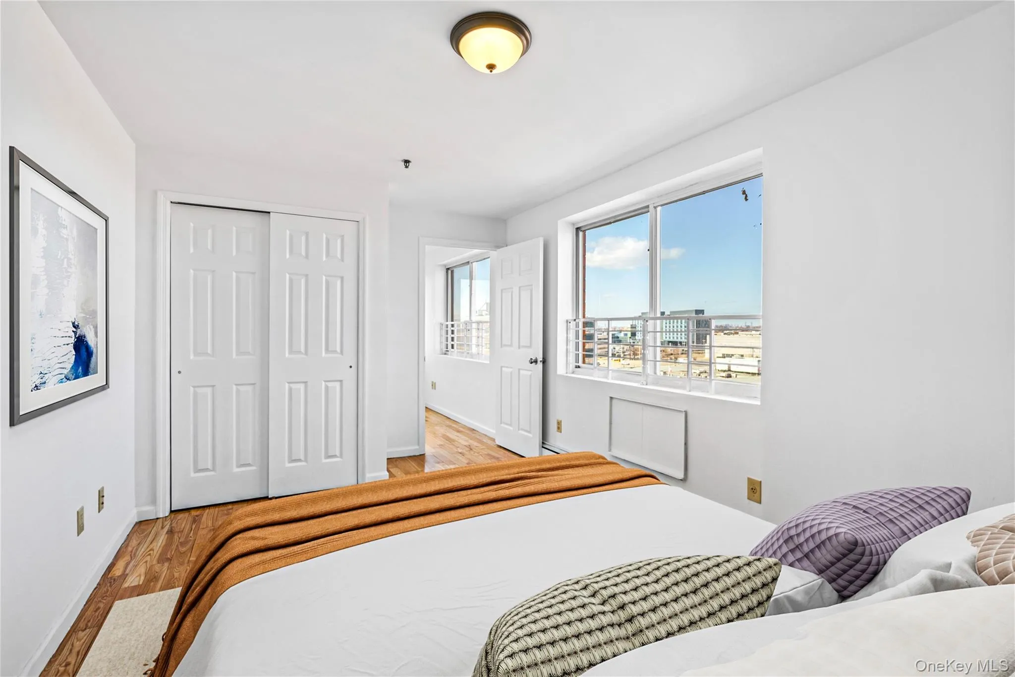 Virtual Staged Bedroom featuring wood finished floors, baseboards, and a closet Virtual Staged Bedroom featuring wood finished floors, baseboards, and a closet