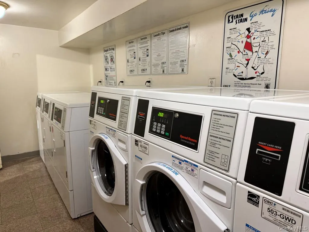 Shared laundry featuring washer and dryer and baseboards Shared laundry featuring washer and dryer and baseboards